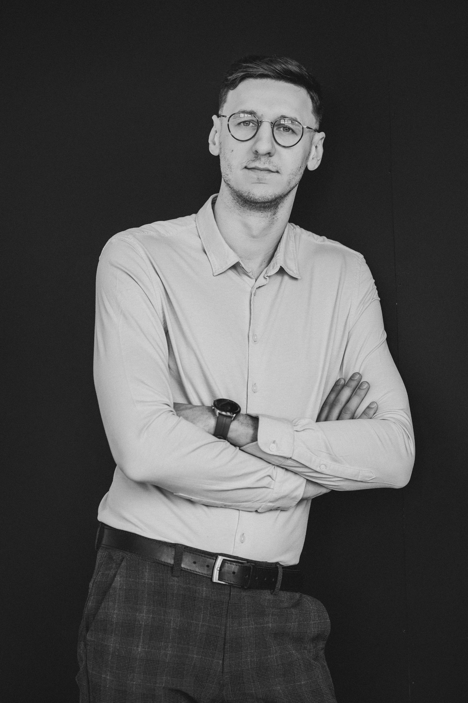 Black and white portrait series of a person in white polo shirt with crossed arms.