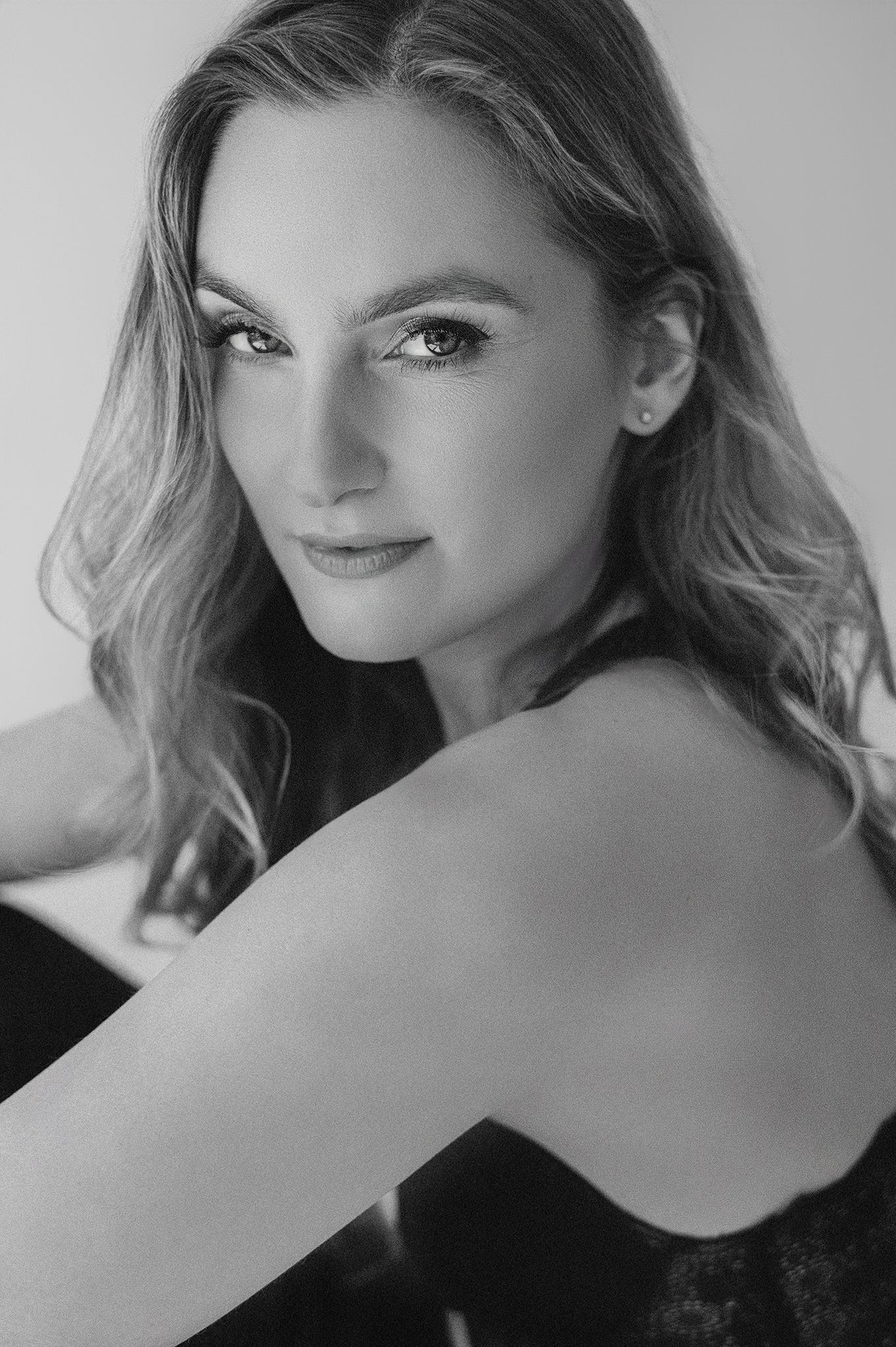 A black and white portrait showing elegant makeup and styled waves.