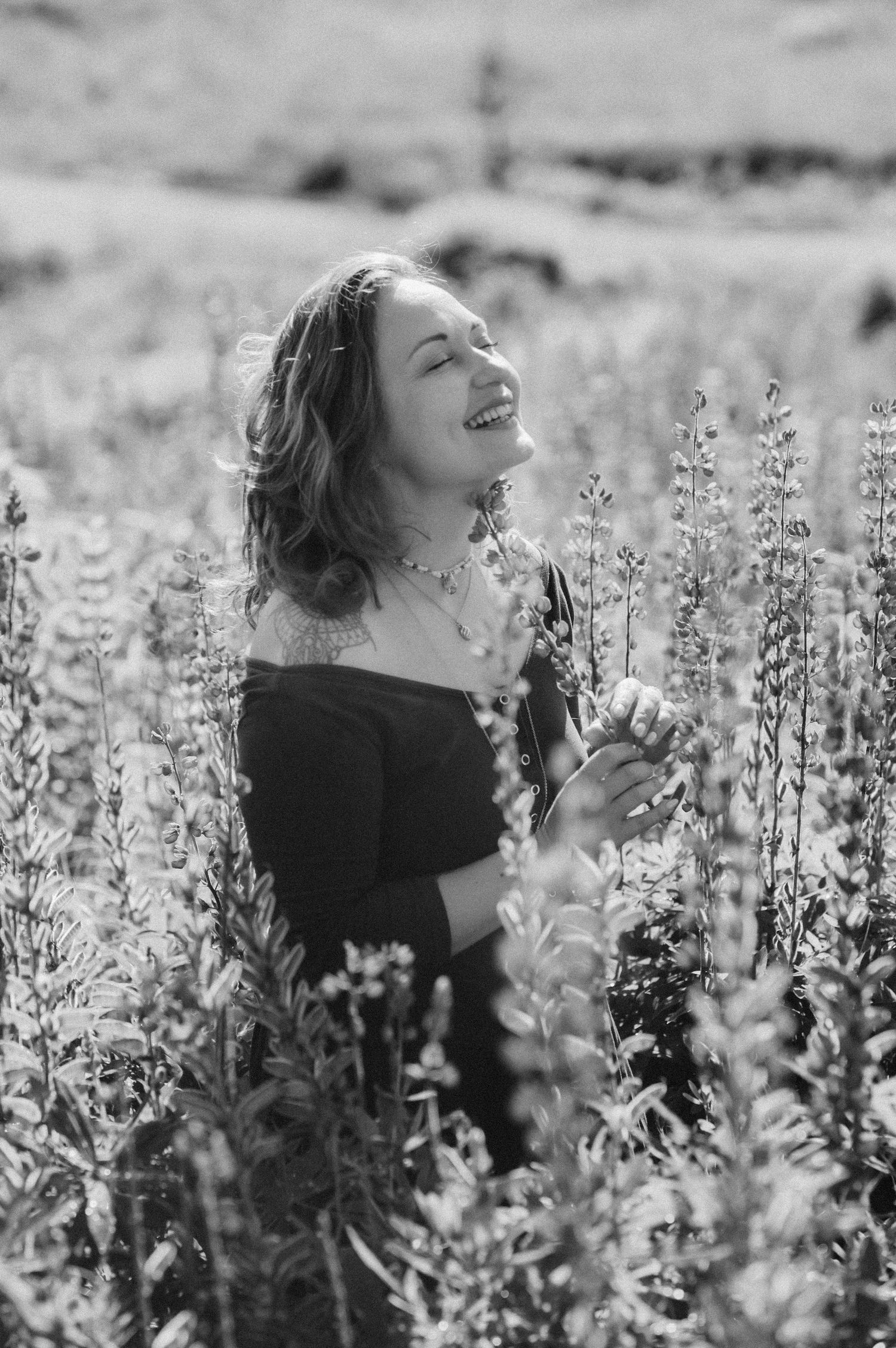 Serene black and white portraits in a field of blooming wildflowers.