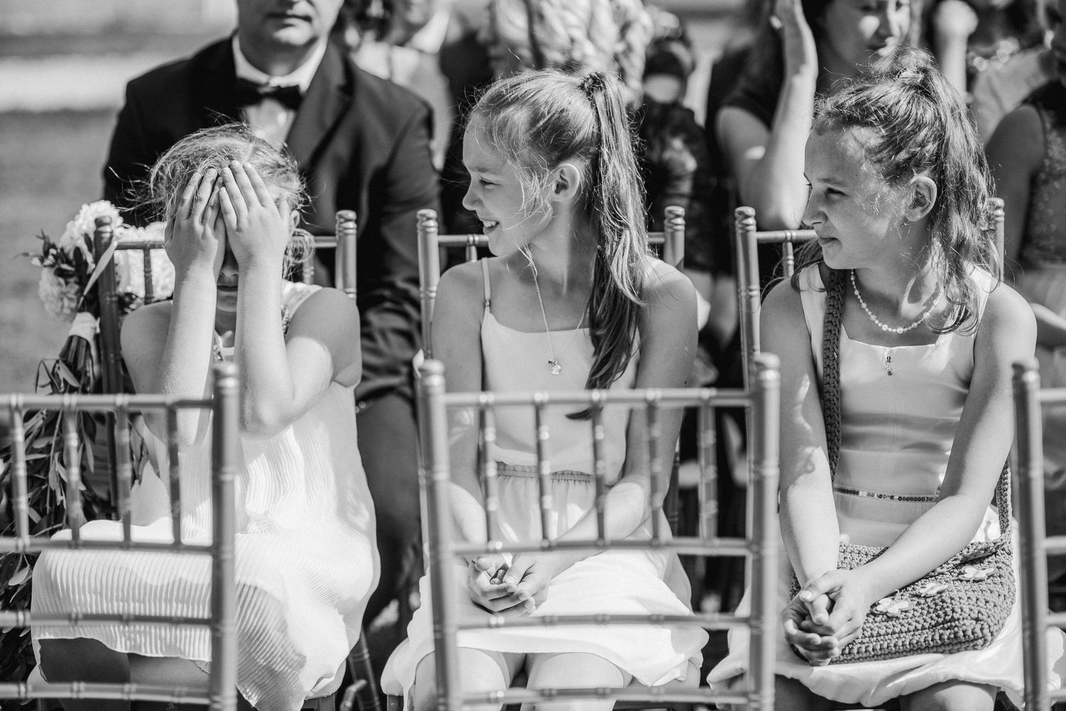 Candid wedding reception moments captured in black and white showing guests mingling outdoors.