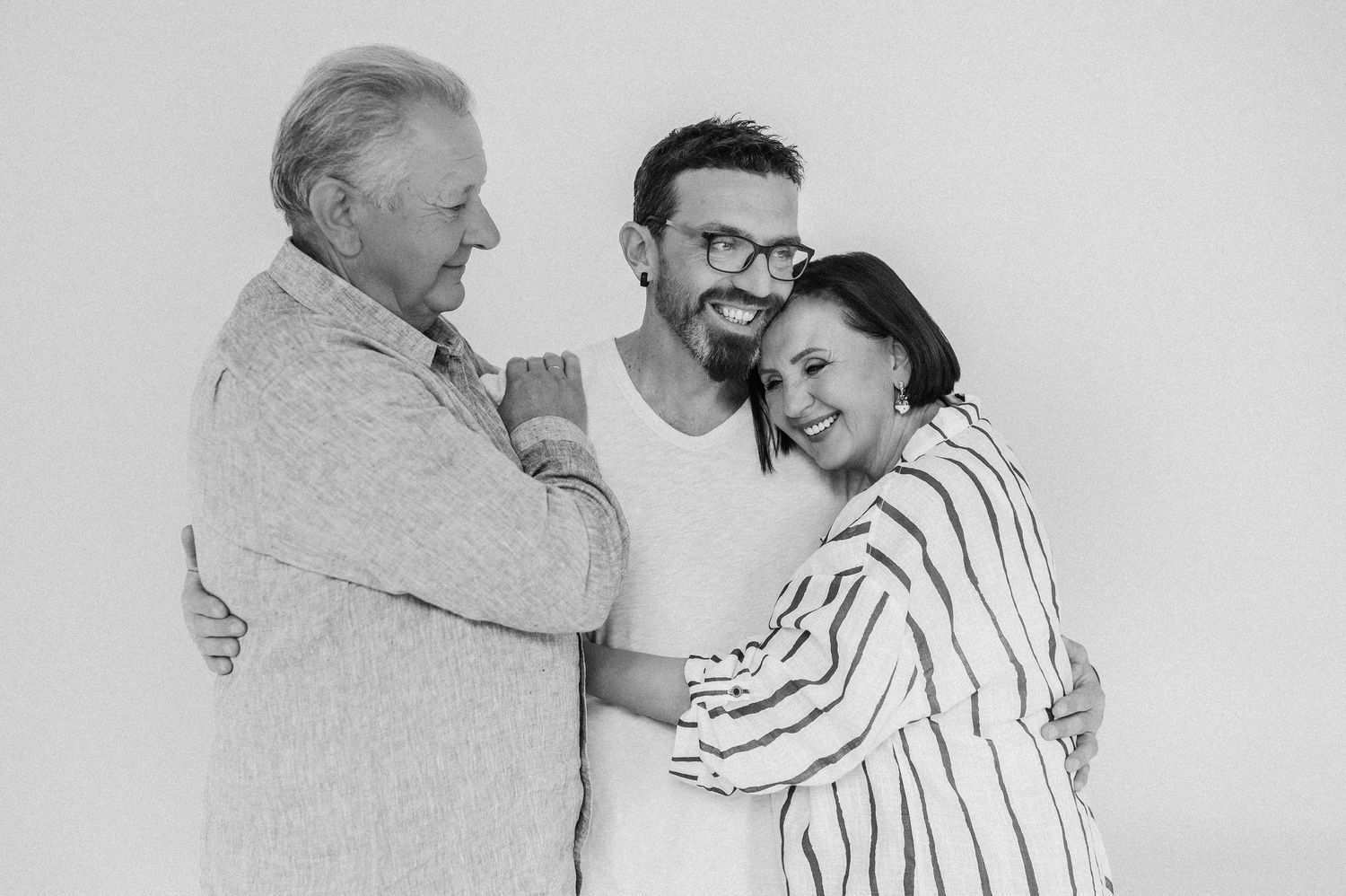 Series of intimate black and white photos showing tender moments between a couple.