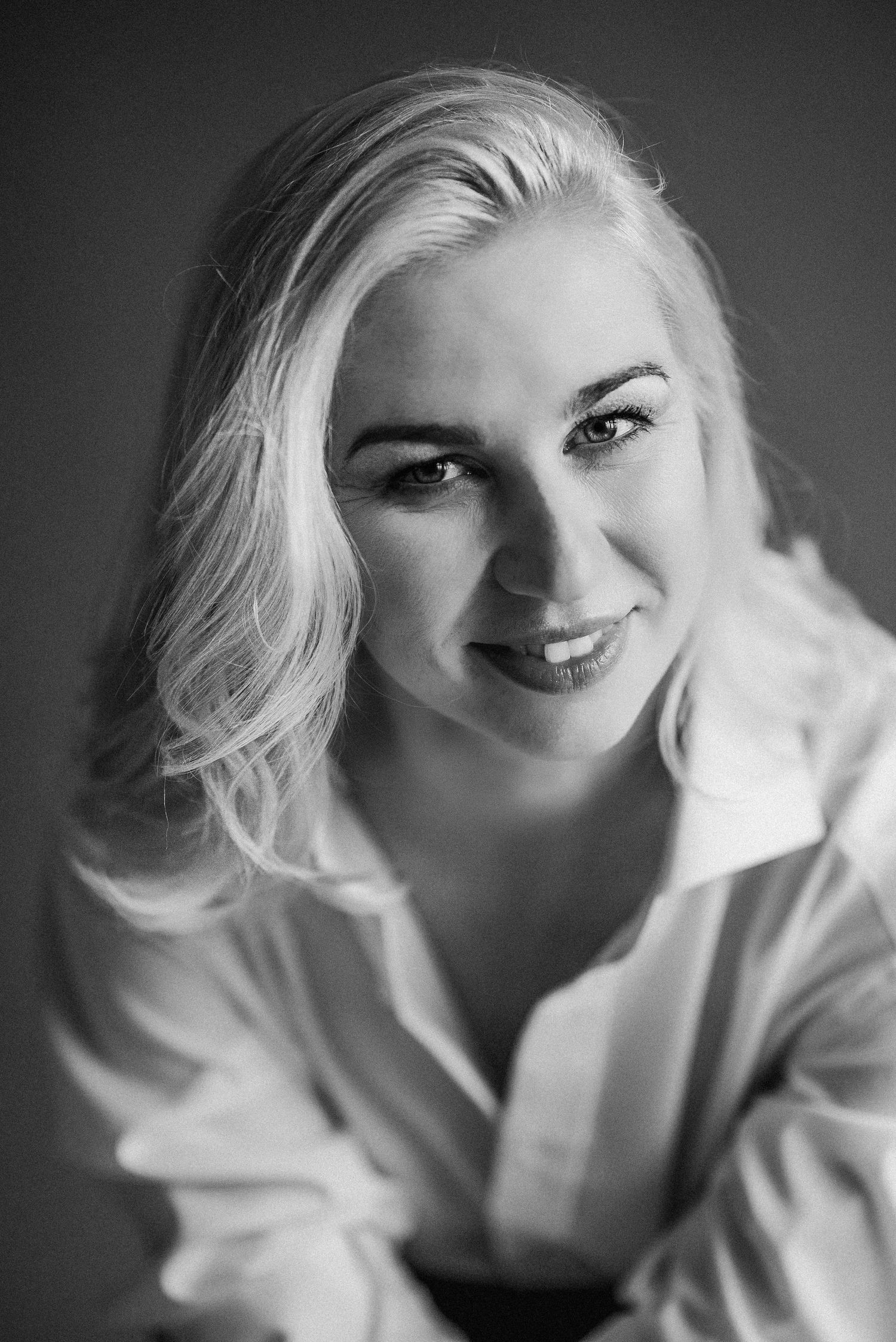 Artistic black and white close-up portraits showing expressive poses in white clothing.