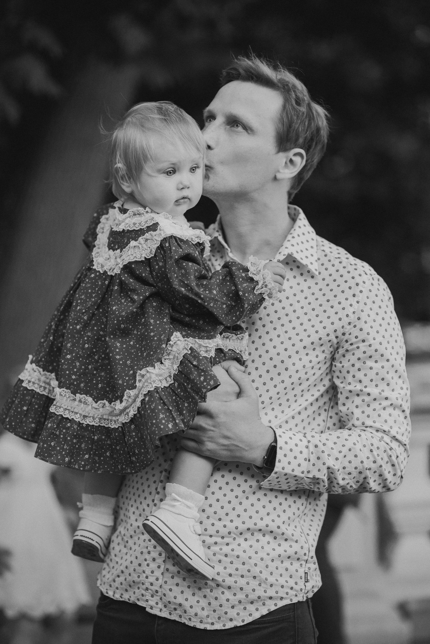 Black and white portraits showing tender moments between parent and child in polka dot and lace clothing.