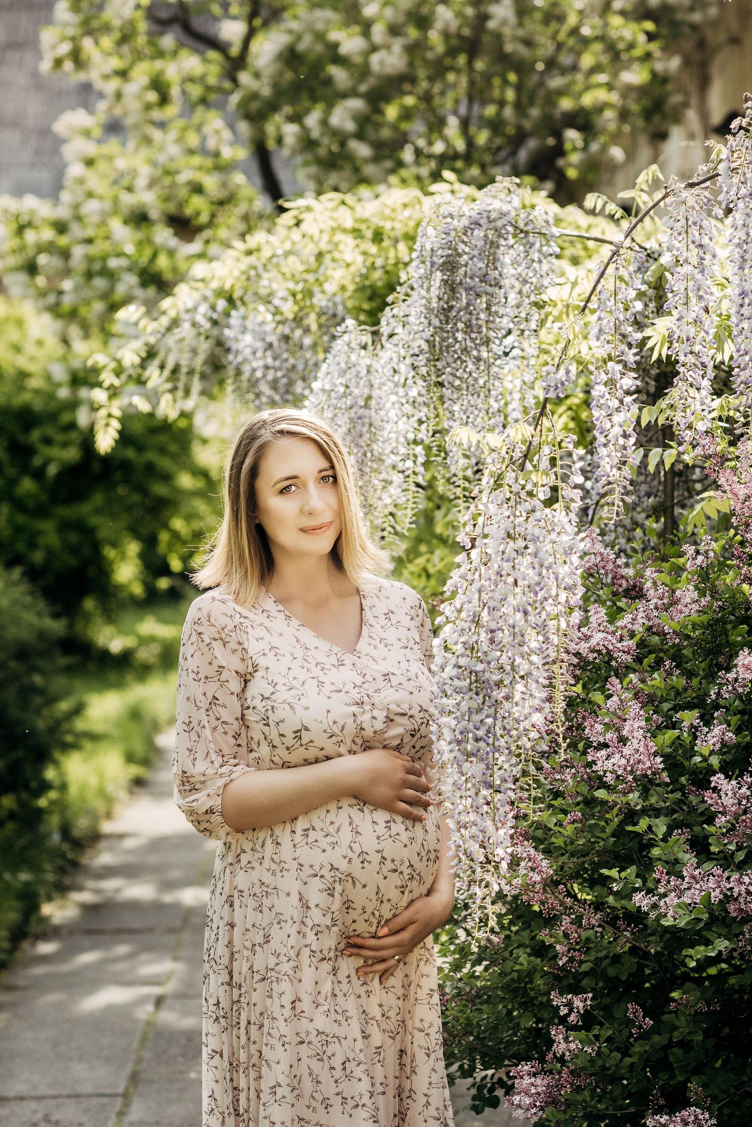 Spring garden photoshoot with blooming white cherry blossoms and soft natural lighting.