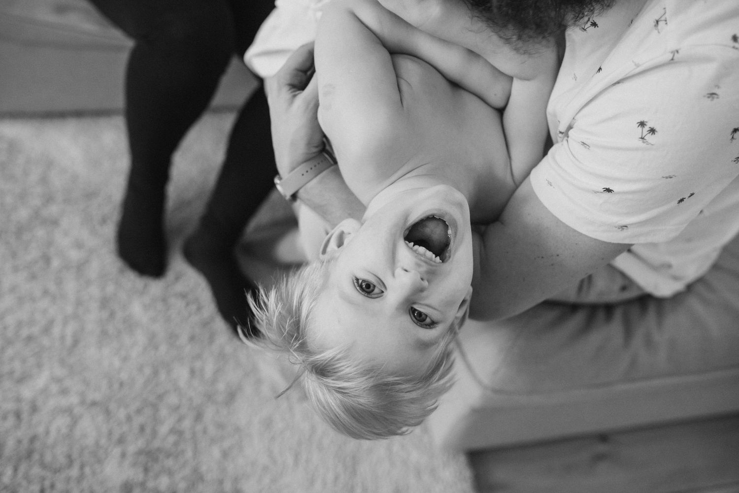 Intimate family moment captured in black and white photography.