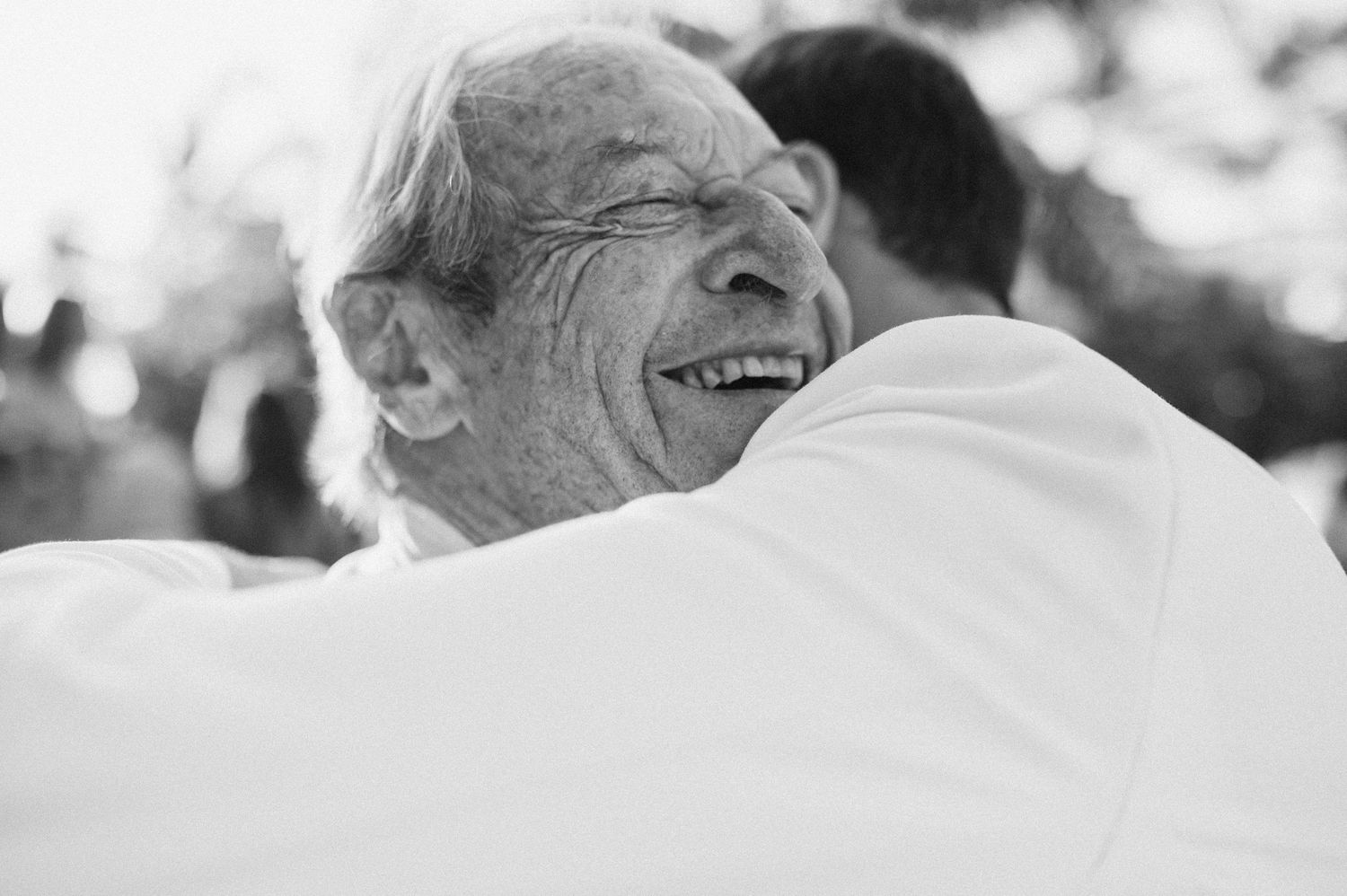A candid black and white photo capturing a joyful moment of laughter.