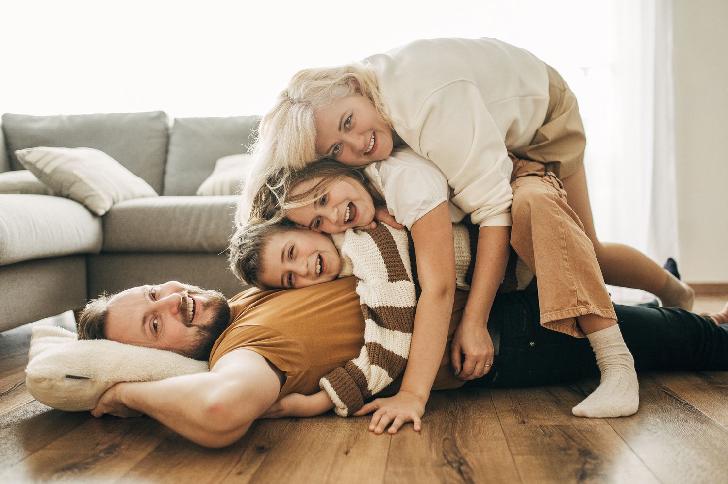Candid lifestyle photo showing relaxed moments on living room floor.