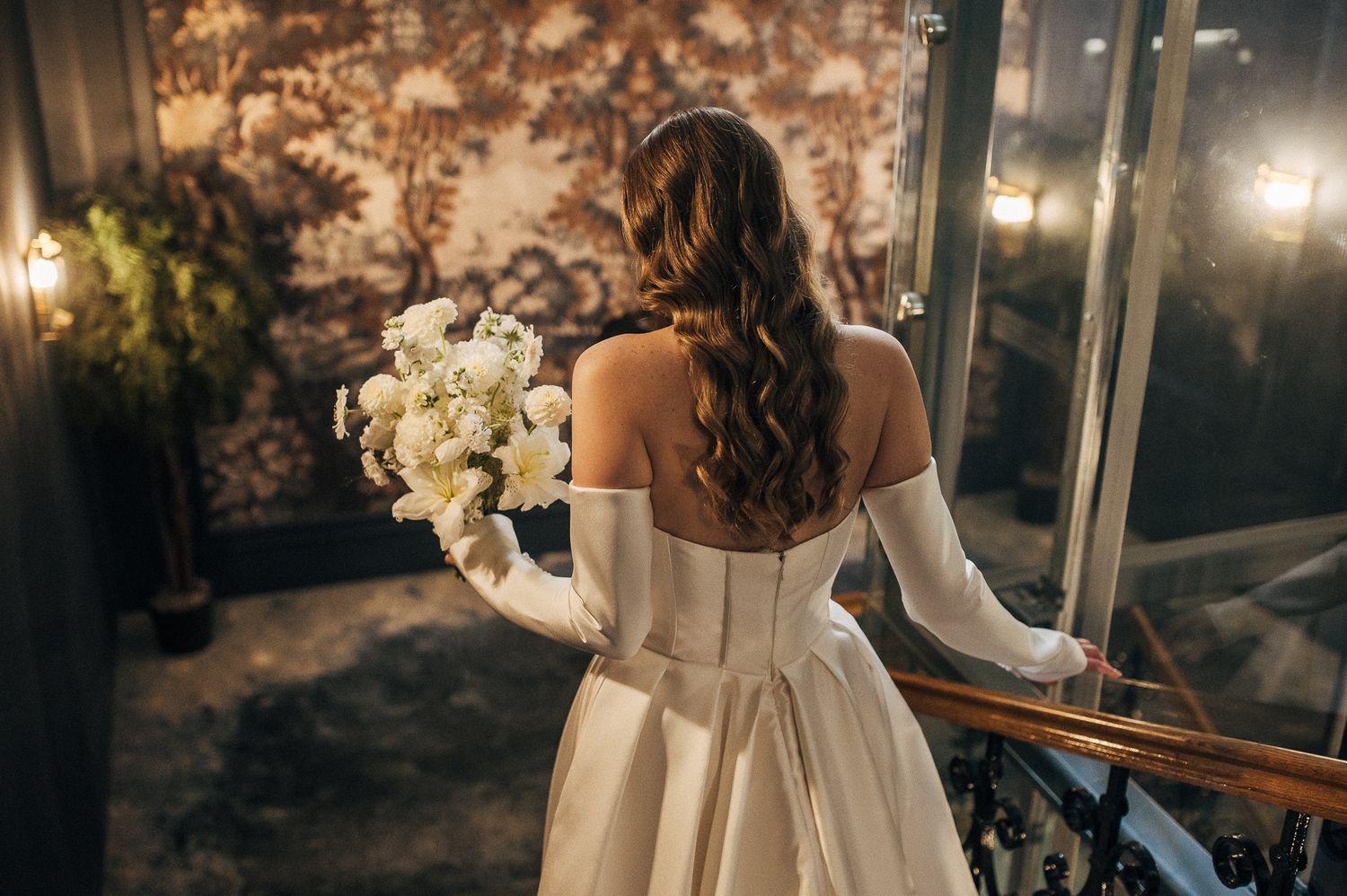 Romantic wedding reception setting with elegant decor and warm lighting at night.
