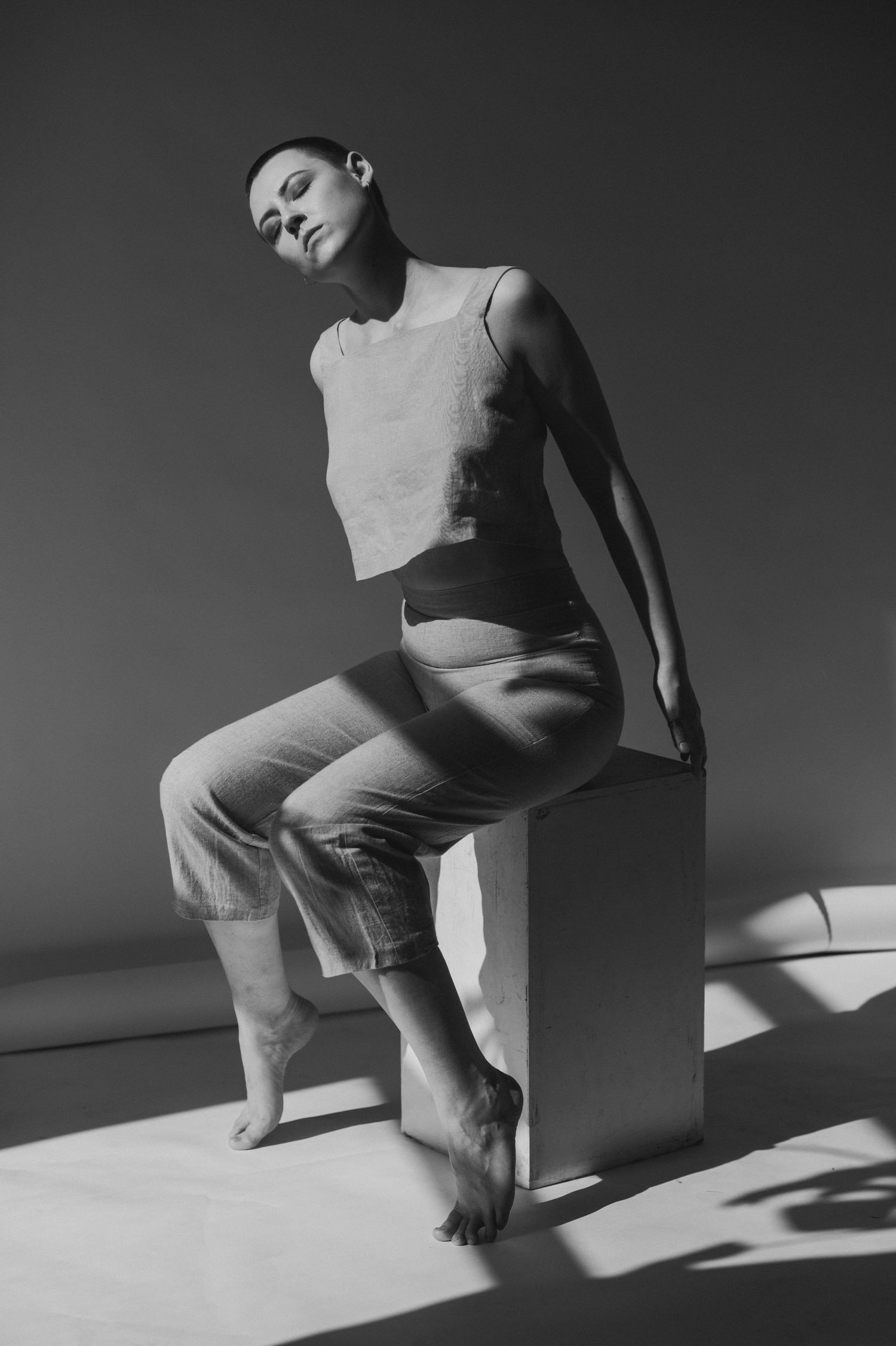 Minimalist black and white series showing abstract body movements in harsh lighting.