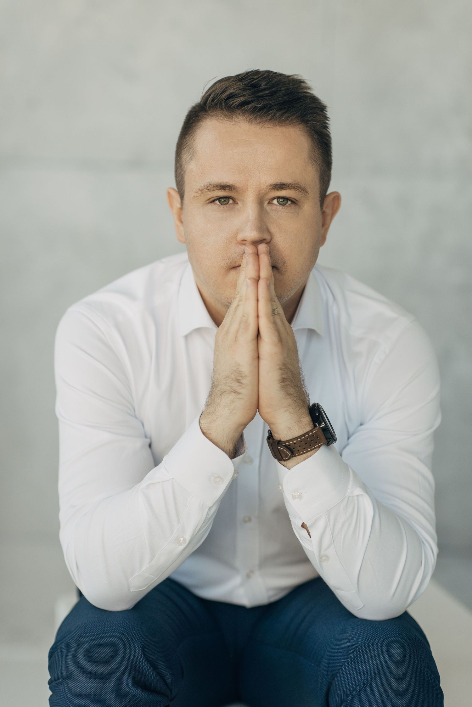Series of thoughtful poses showing someone in a white shirt with hands near face.