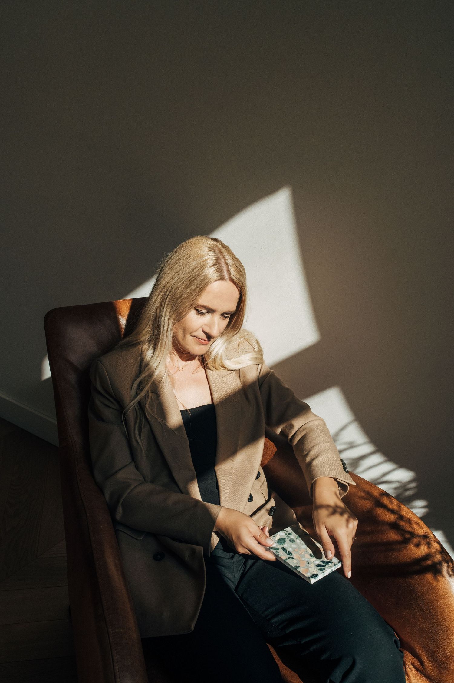 Dramatic portrait series with moody lighting showing shadows across a couch setting.