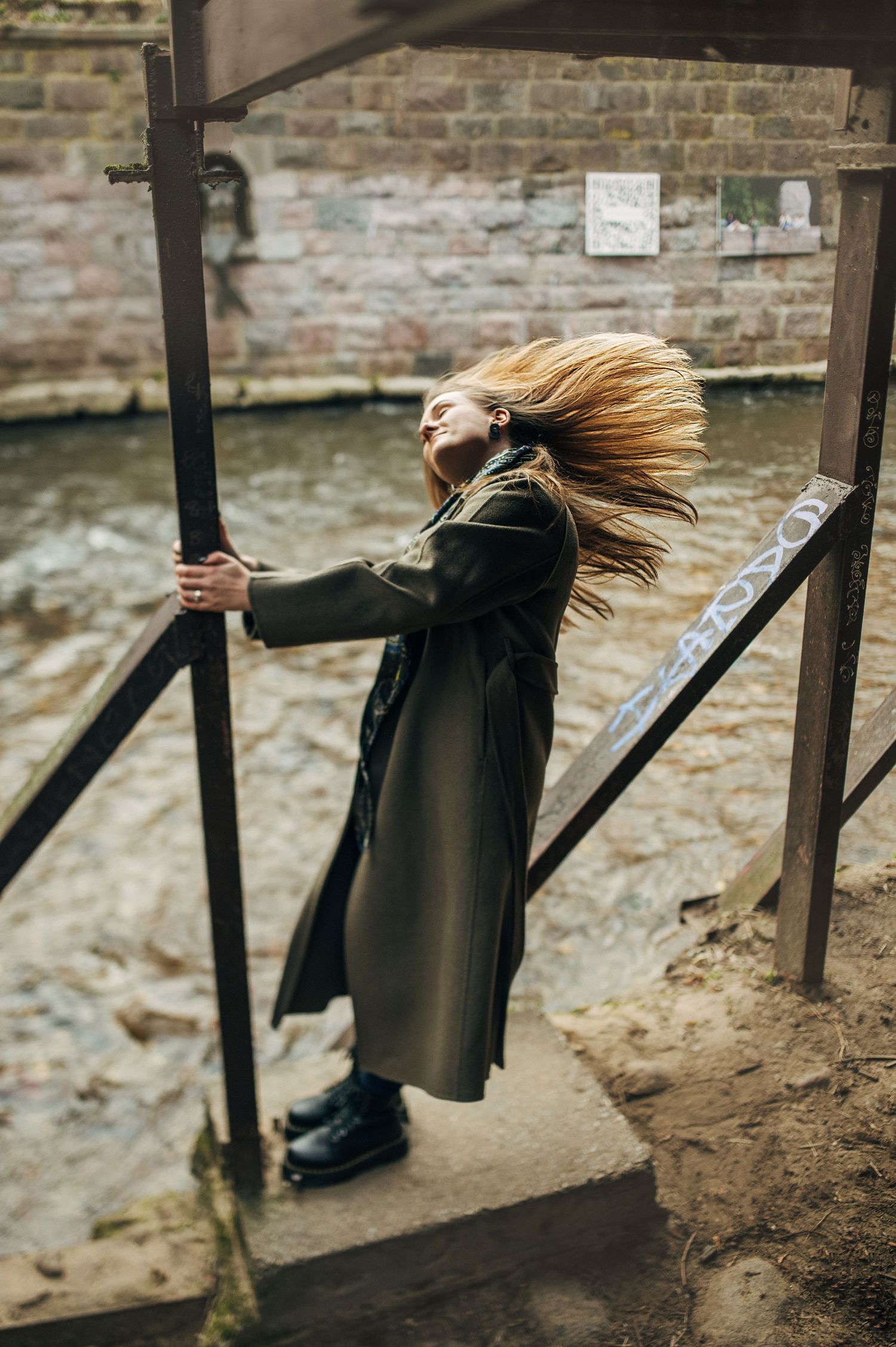 Dramatic motion shots of figure in black coat spinning among wooden posts.