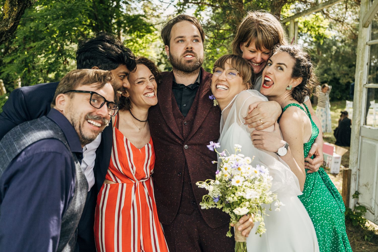 Candid moments of wedding guests laughing and celebrating outdoors.