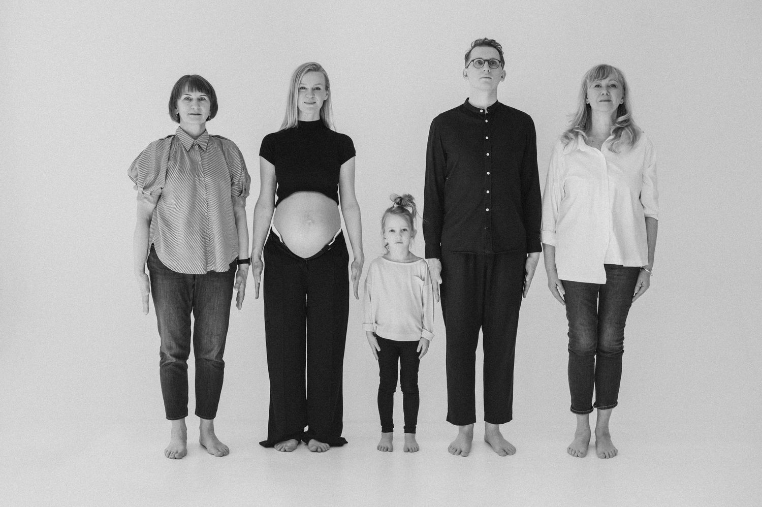 Black and white family lineup portrait showing different generations together.
