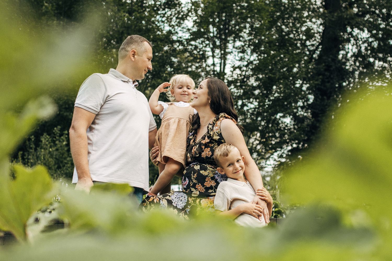 A series of intimate family moments captured in natural outdoor lighting with greenery in background.