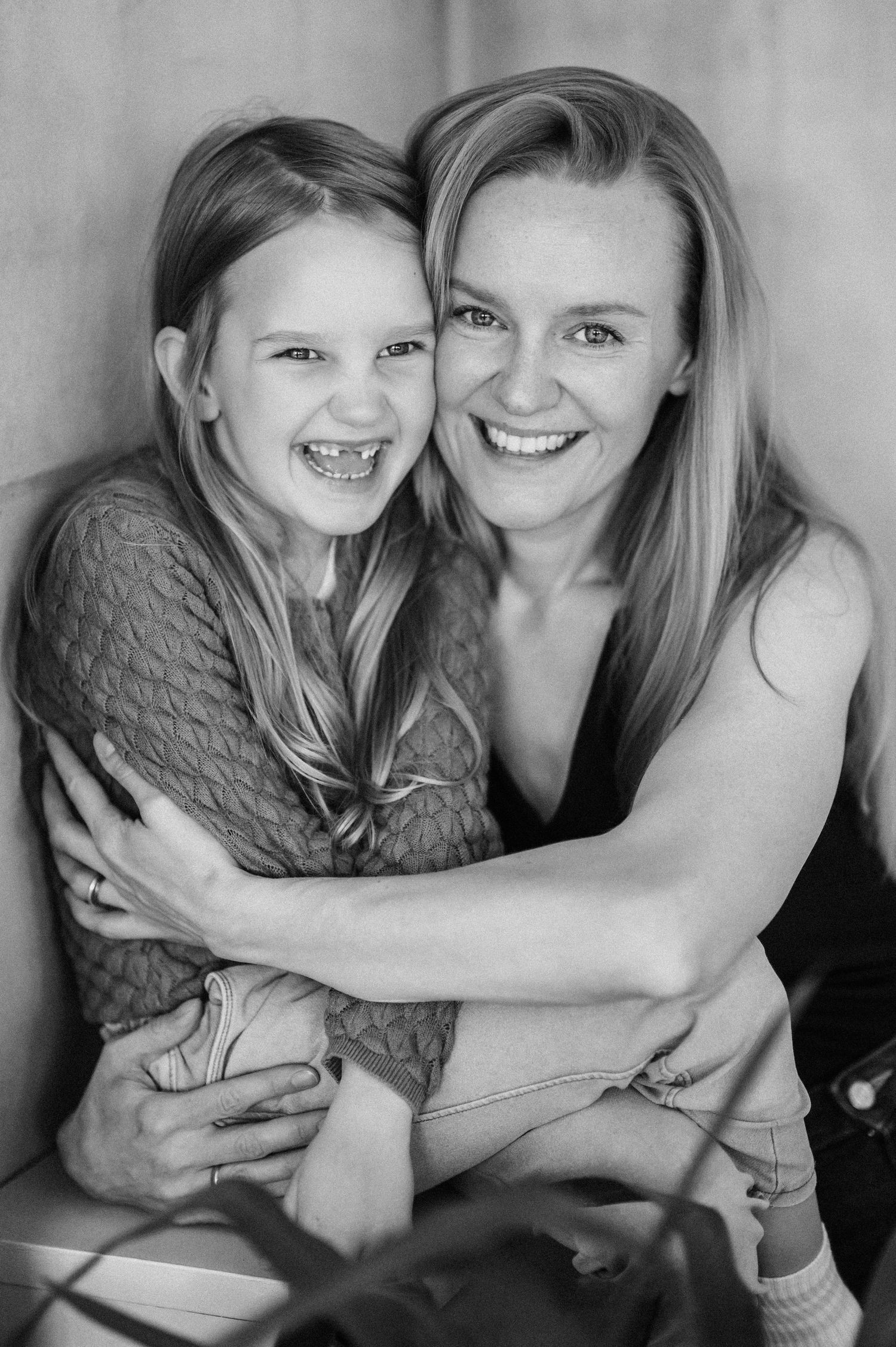 Black and white portrait series capturing joyful embraces and genuine laughter.