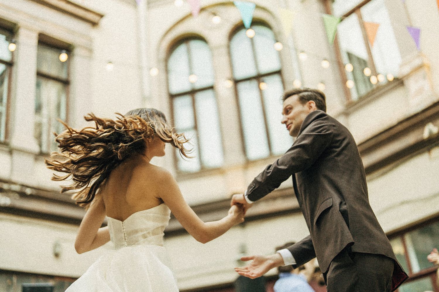 Dynamic dancing moment captured during wedding celebration.