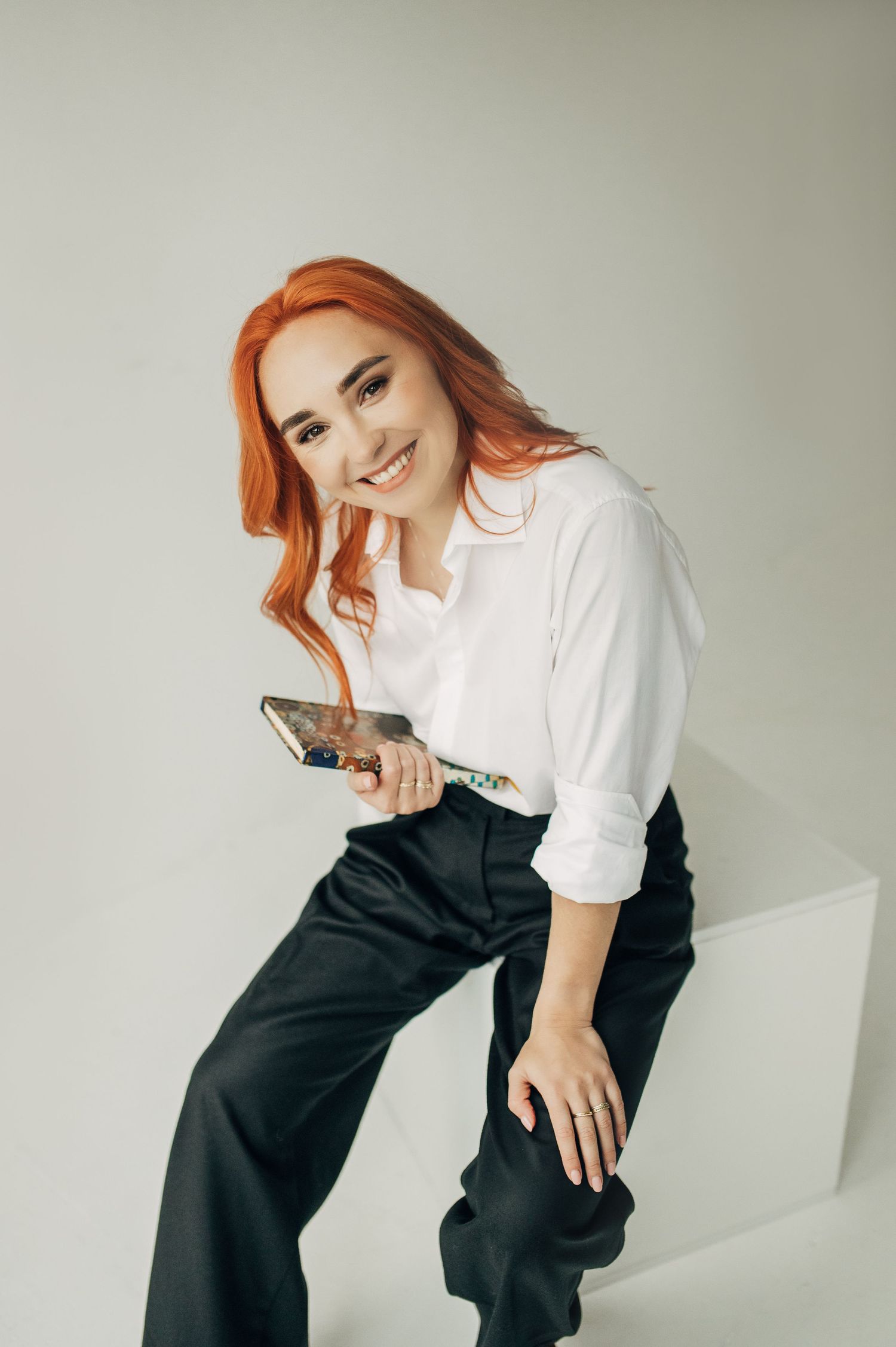 Stylish minimal fashion pose against light background.