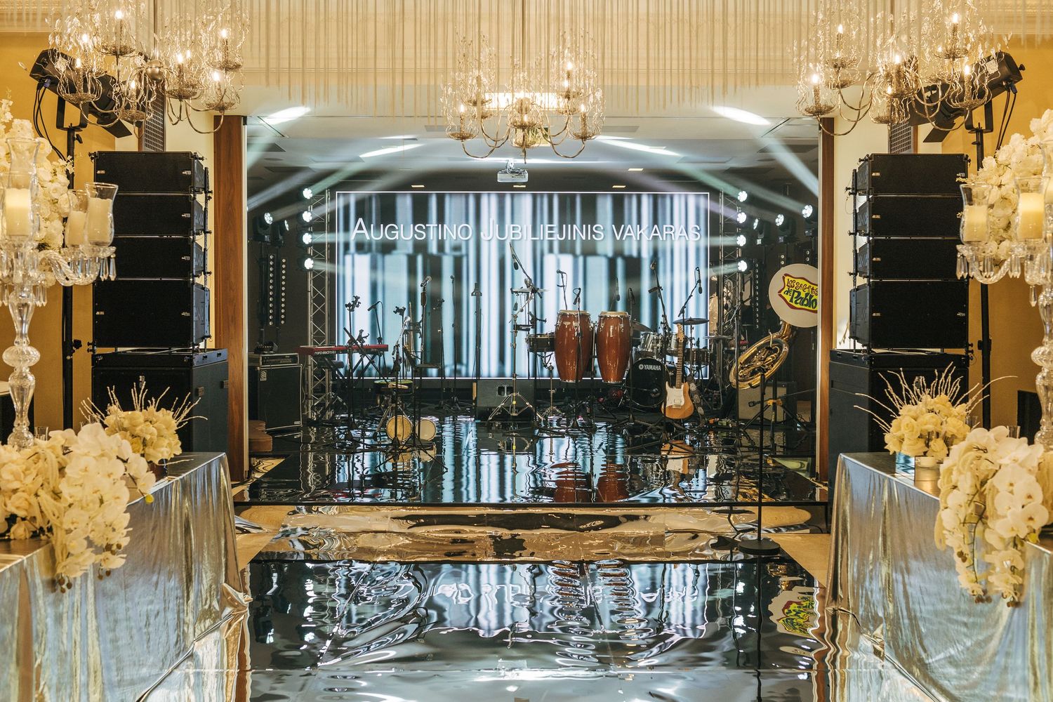 Luxurious fitness center interior with crystal chandeliers and modern exercise equipment in an elegant setting.