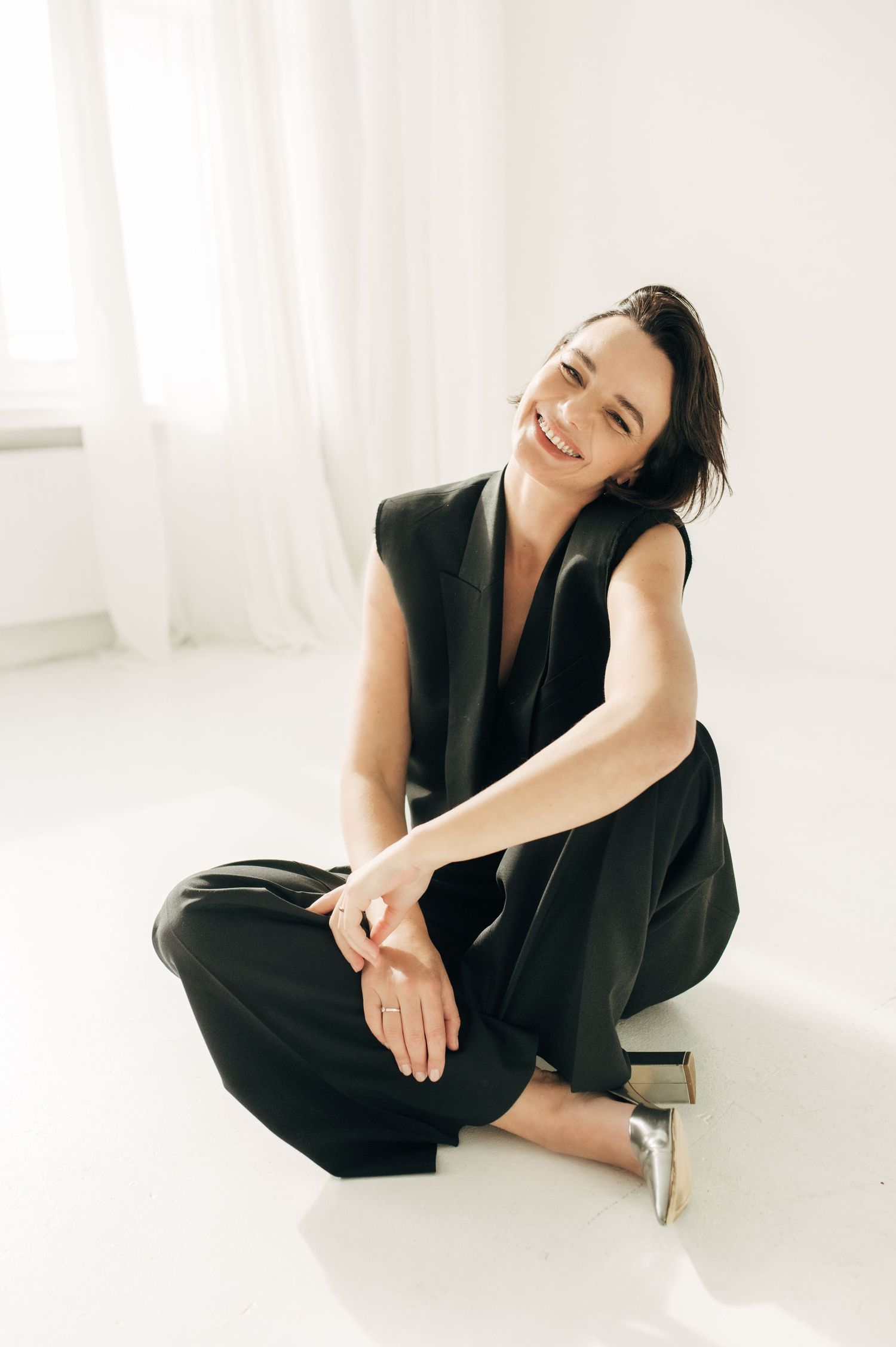 Minimalist studio portraits in black outfit against white background.