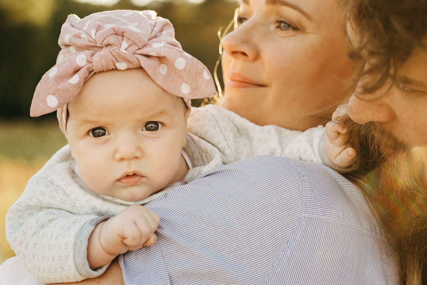 Close up photo in golden sunlight with soft pink clothing details.