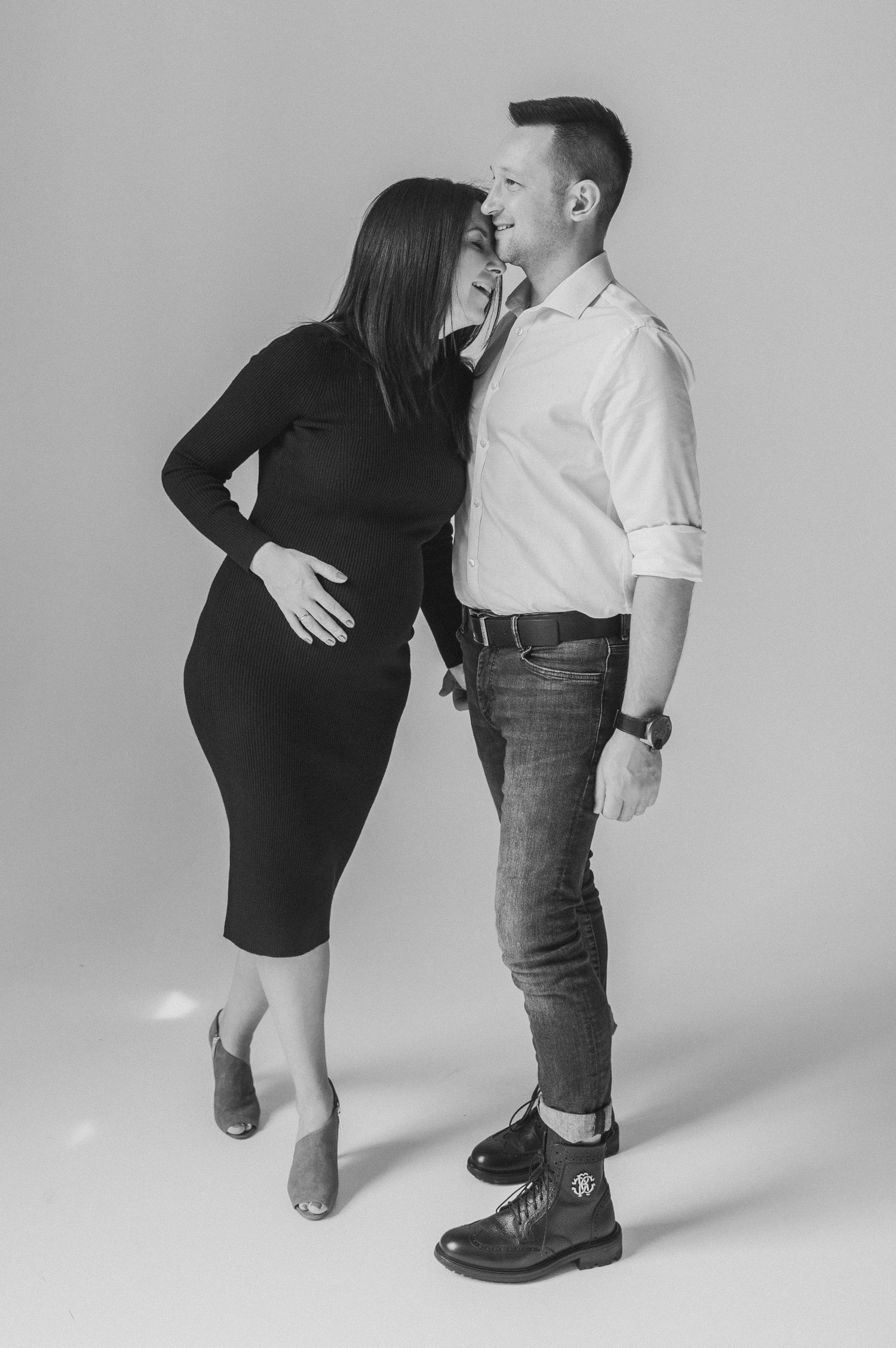 Minimalist black and white maternity photoshoot sequence showing intimate moments.