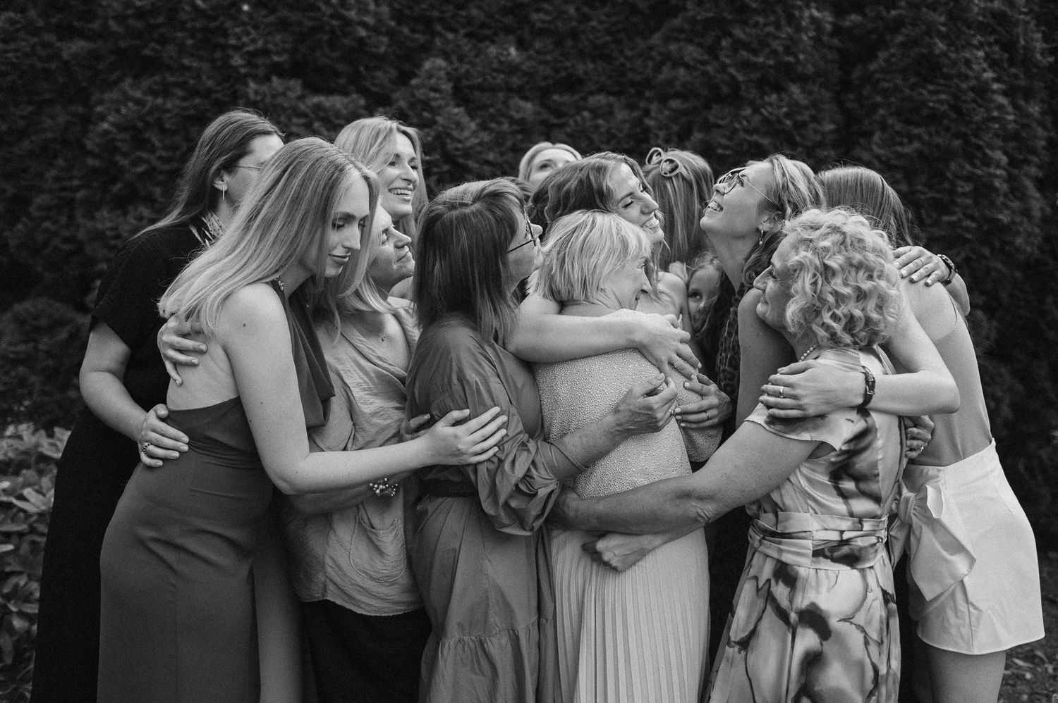 A group of friends pose together in a casual black and white photo series.