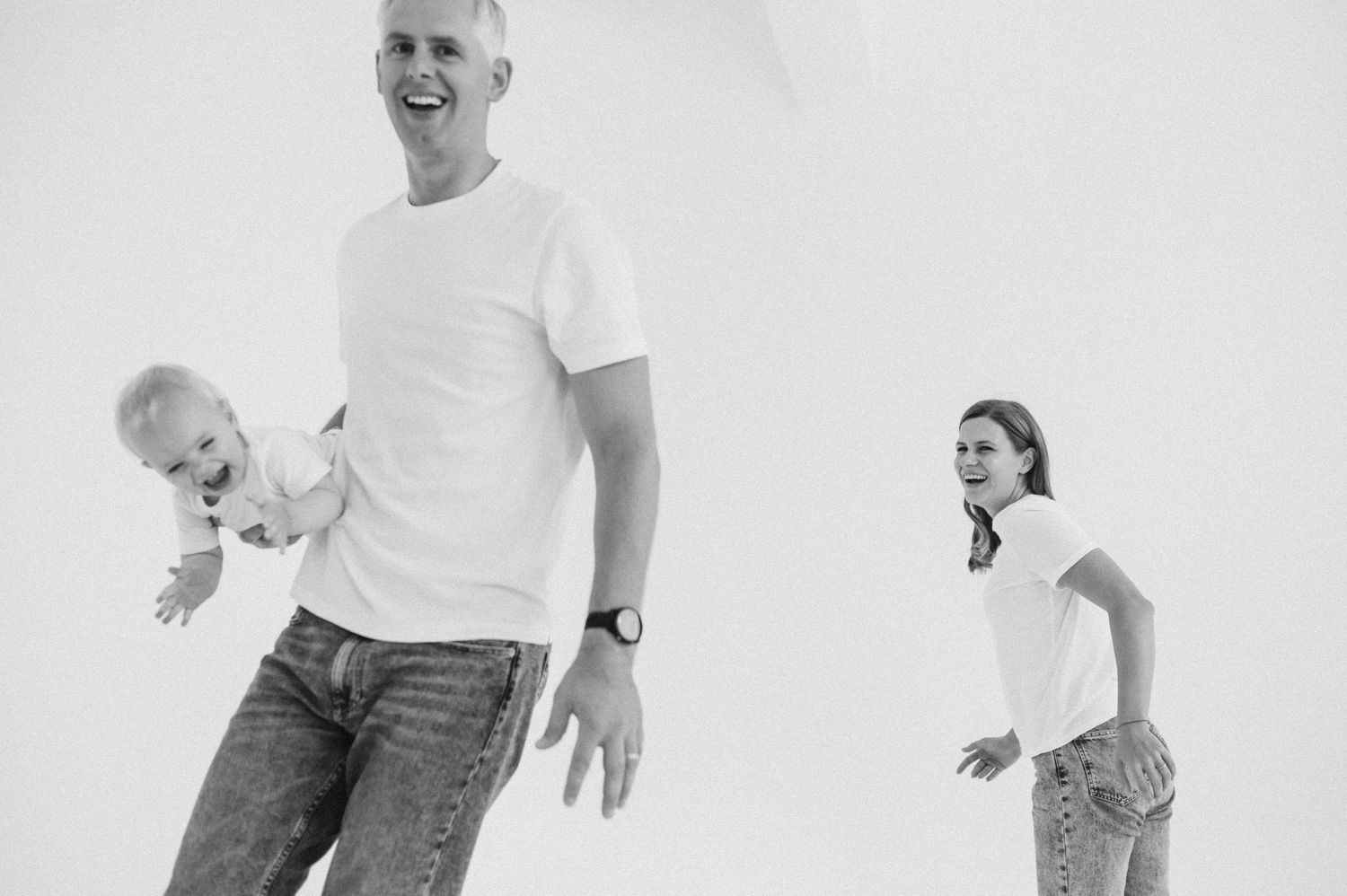 A sequence of black and white photos showing a person jumping with dynamic movement against a white background.