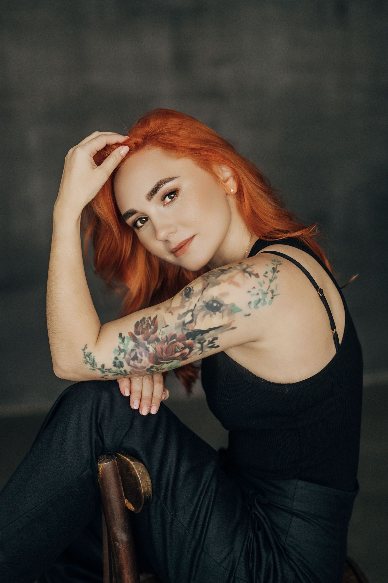 Fashion portrait series showing floral tattoo artwork on model's arm against dark background.