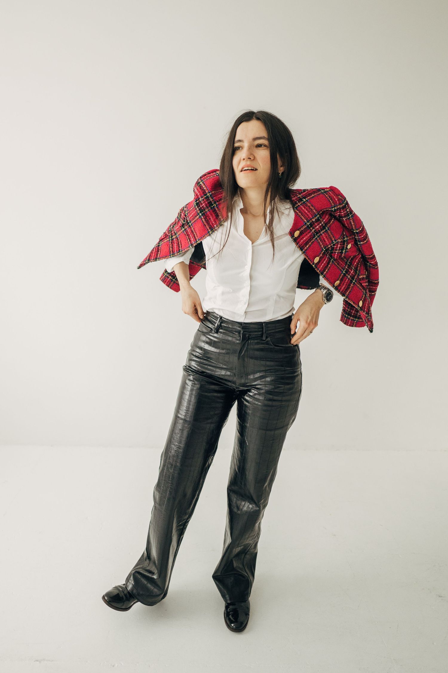 Dynamic poses in casual outfit with plaid shirt and jeans against white background.
