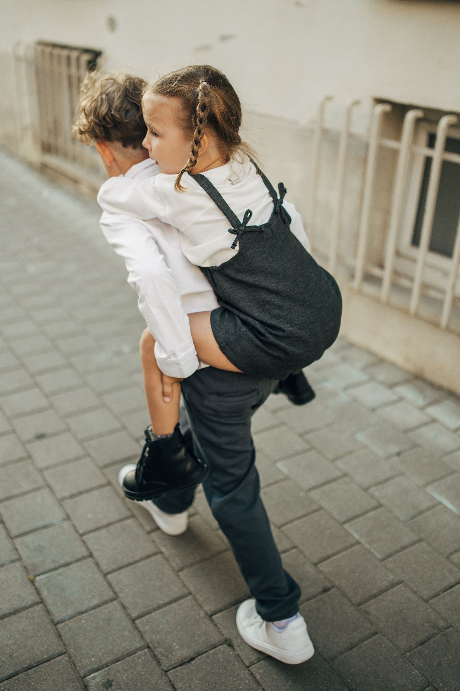 Playful interaction captured in a series of movement shots on a paved street.