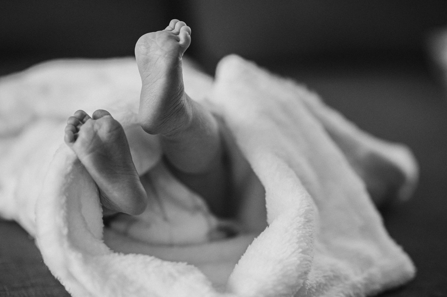 Black and white close-up shots of tender moments with blankets.