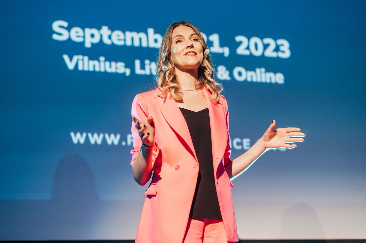 Conference stage with blue backdrop displaying September 2023 date text.
