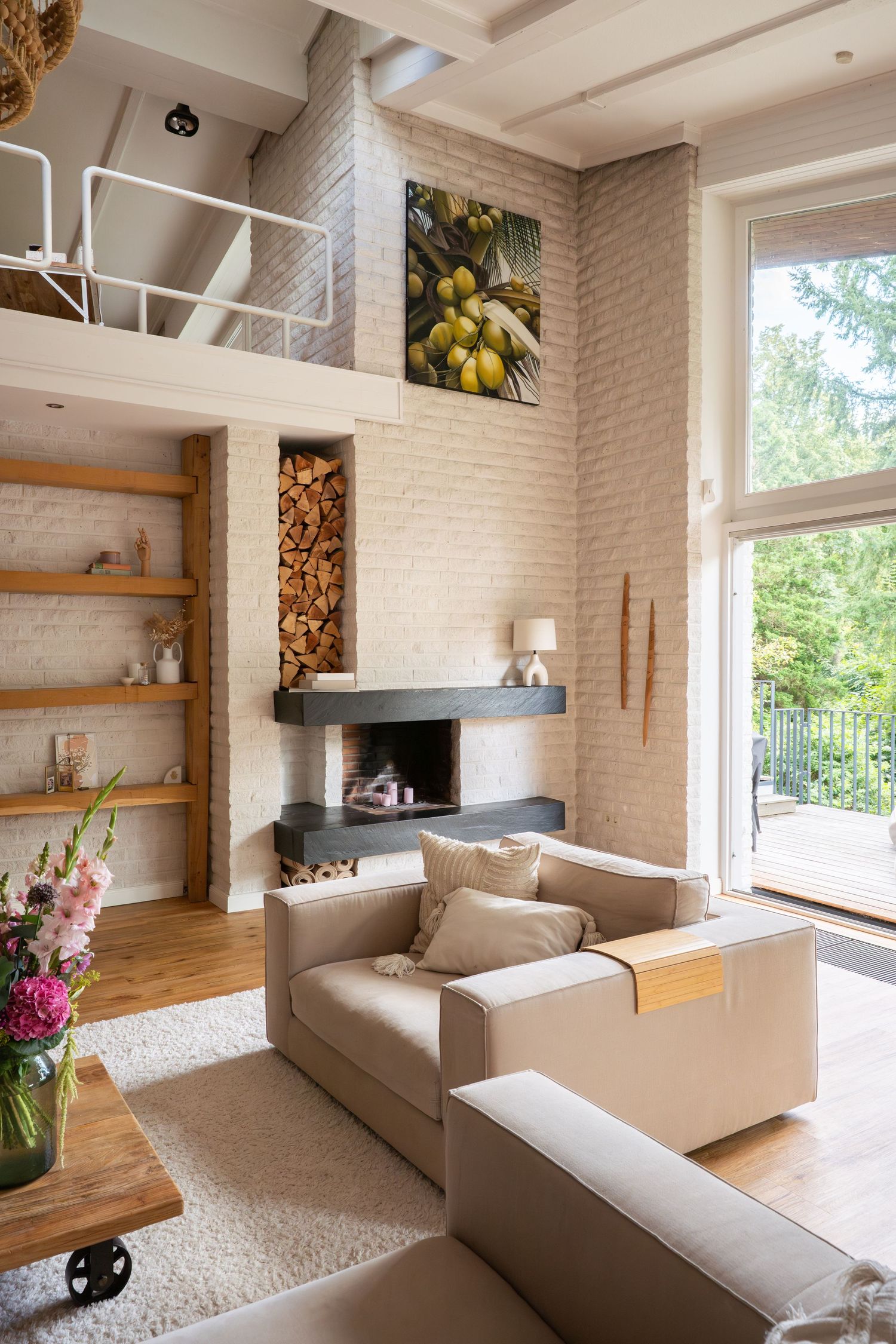 Modern living room interior with cream sofa, wooden shelves, and large windows showcasing a bright, minimalist design.
