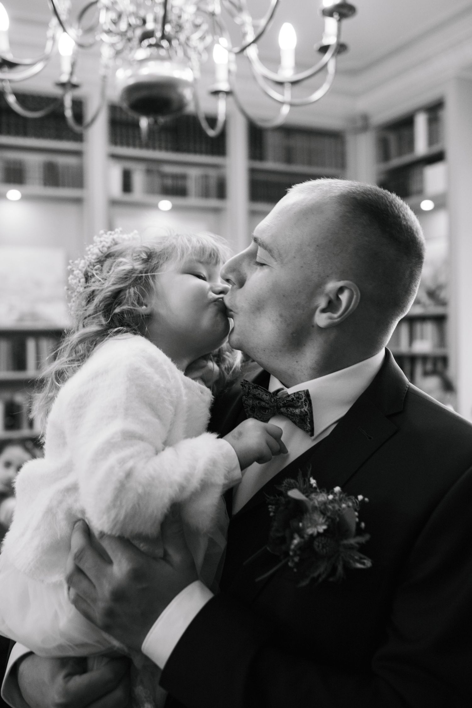 A romantic black and white wedding photo sequence showing four tender kisses between newlyweds.