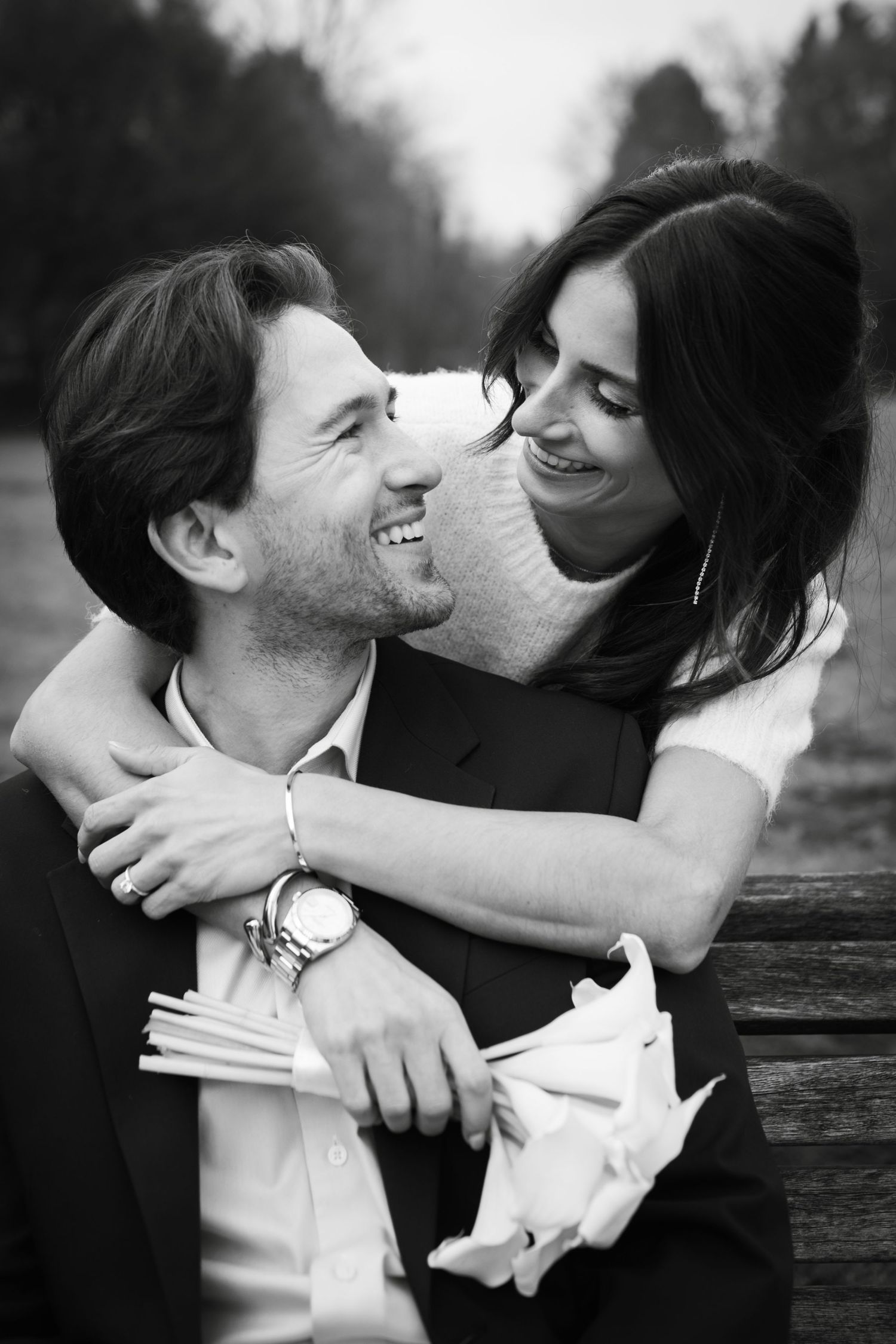 A romantic black and white photo series showing a couple embracing and laughing together in candid moments.