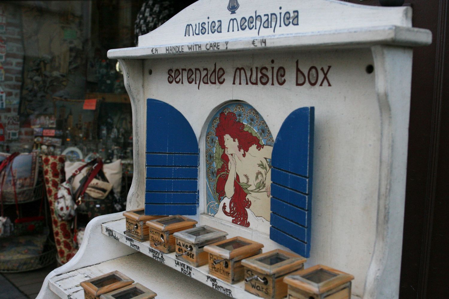 A music display stand in front of a Stamp Collection store in Ghent, Belgium.