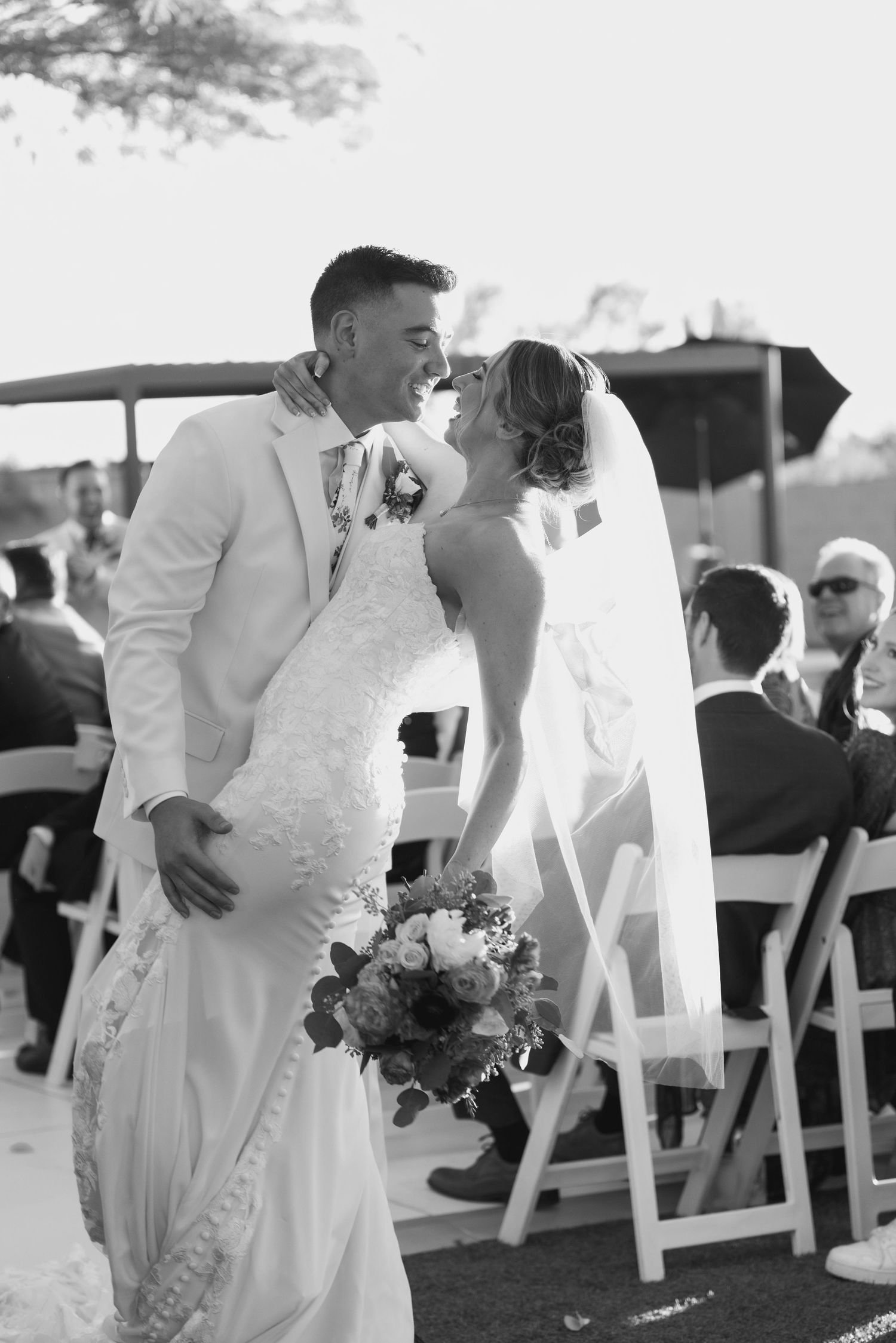 Black and white photos of a wedding ceremony with white chairs and guests outdoors.