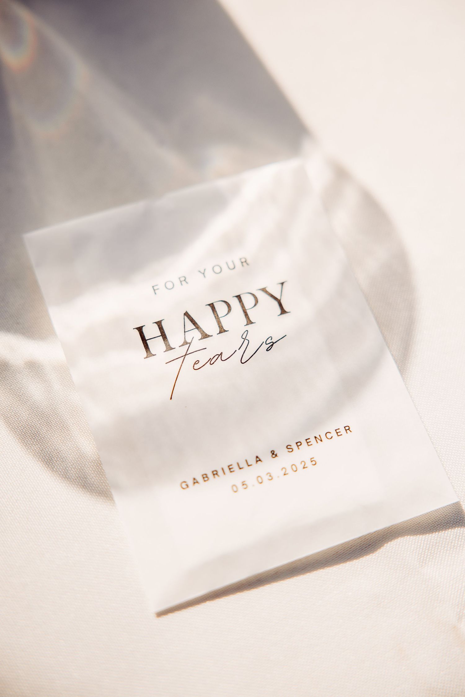 Wedding tissue packet labeled 'For Your Happy Tears' with gold lettering in elegant typography.