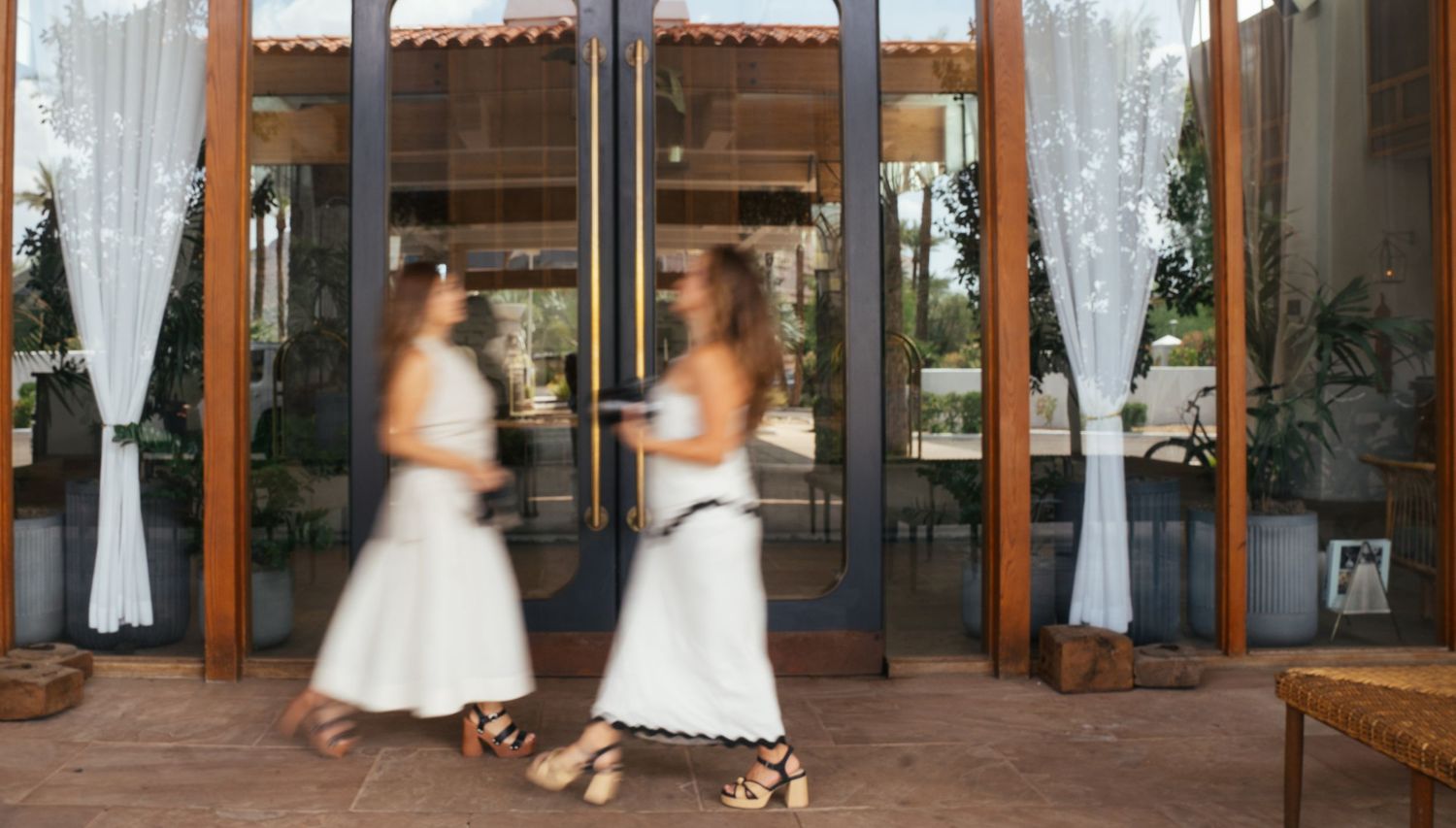 A series of white wedding dress photographs displayed side by side in an elegant wood-framed horizontal collage.