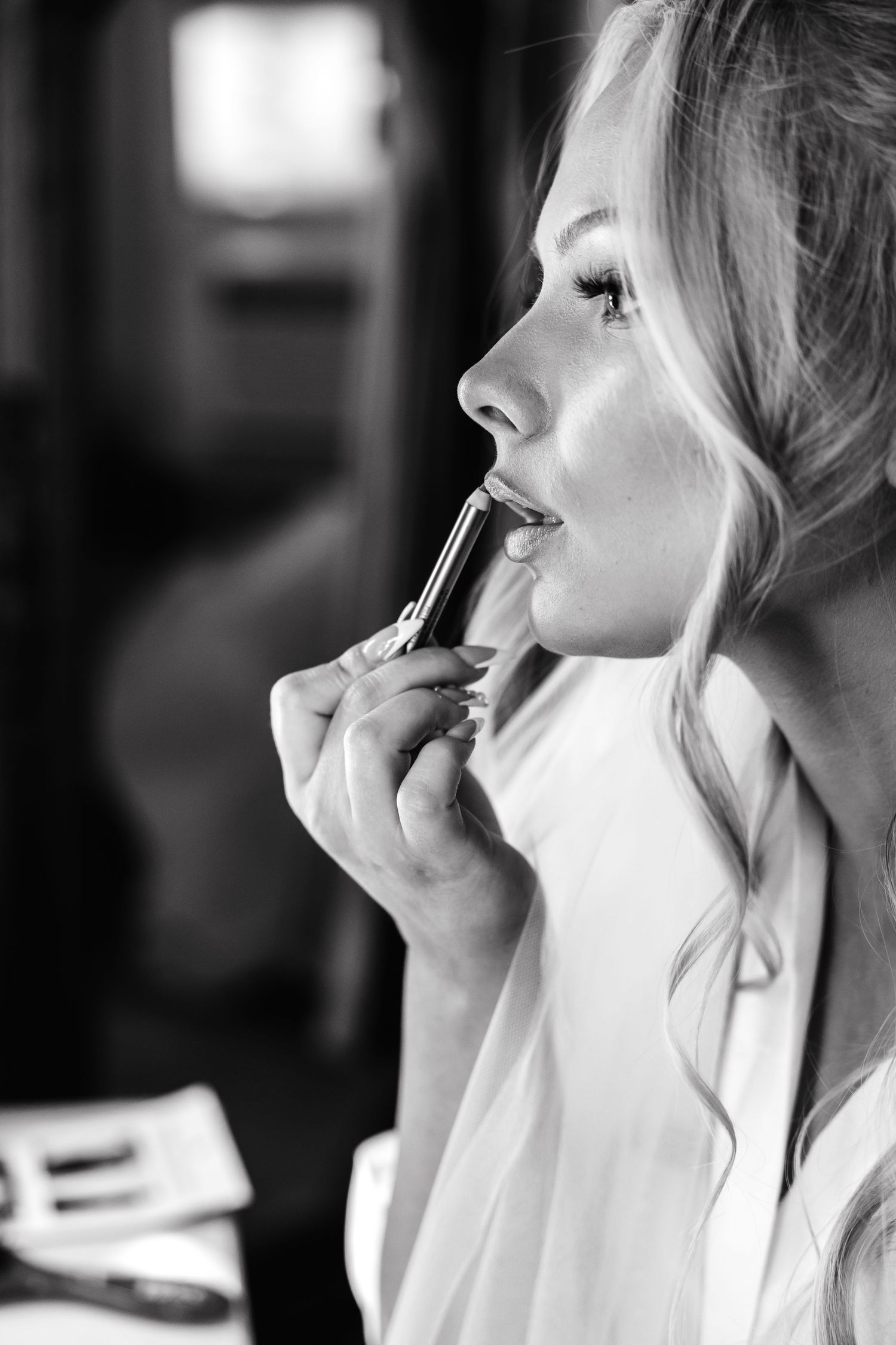 Black and white photo series showing makeup application in profile view.