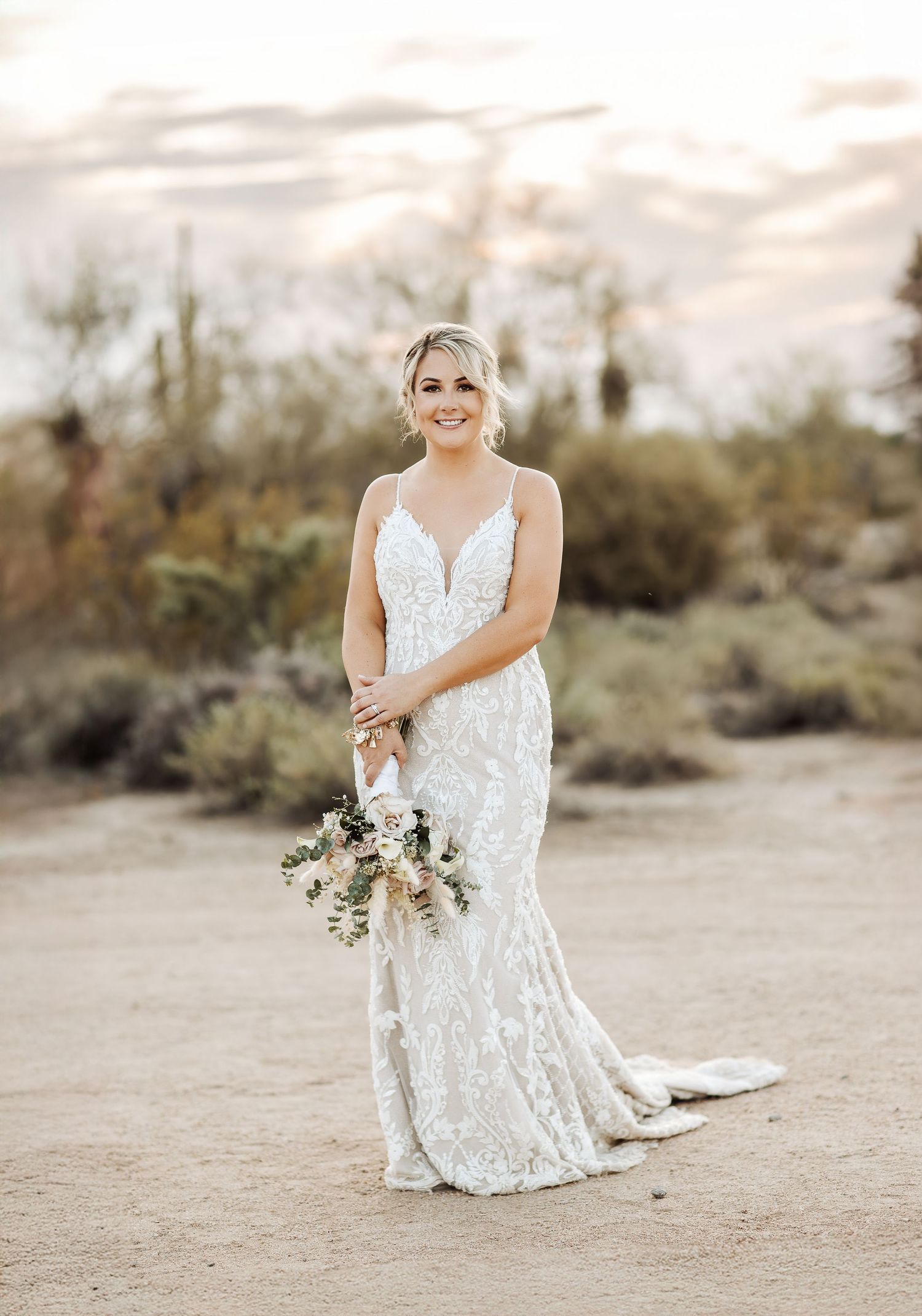 Three elegant desert bridal portraits showcase a white lace dress and neutral bouquet with soft lighting and desert brush.