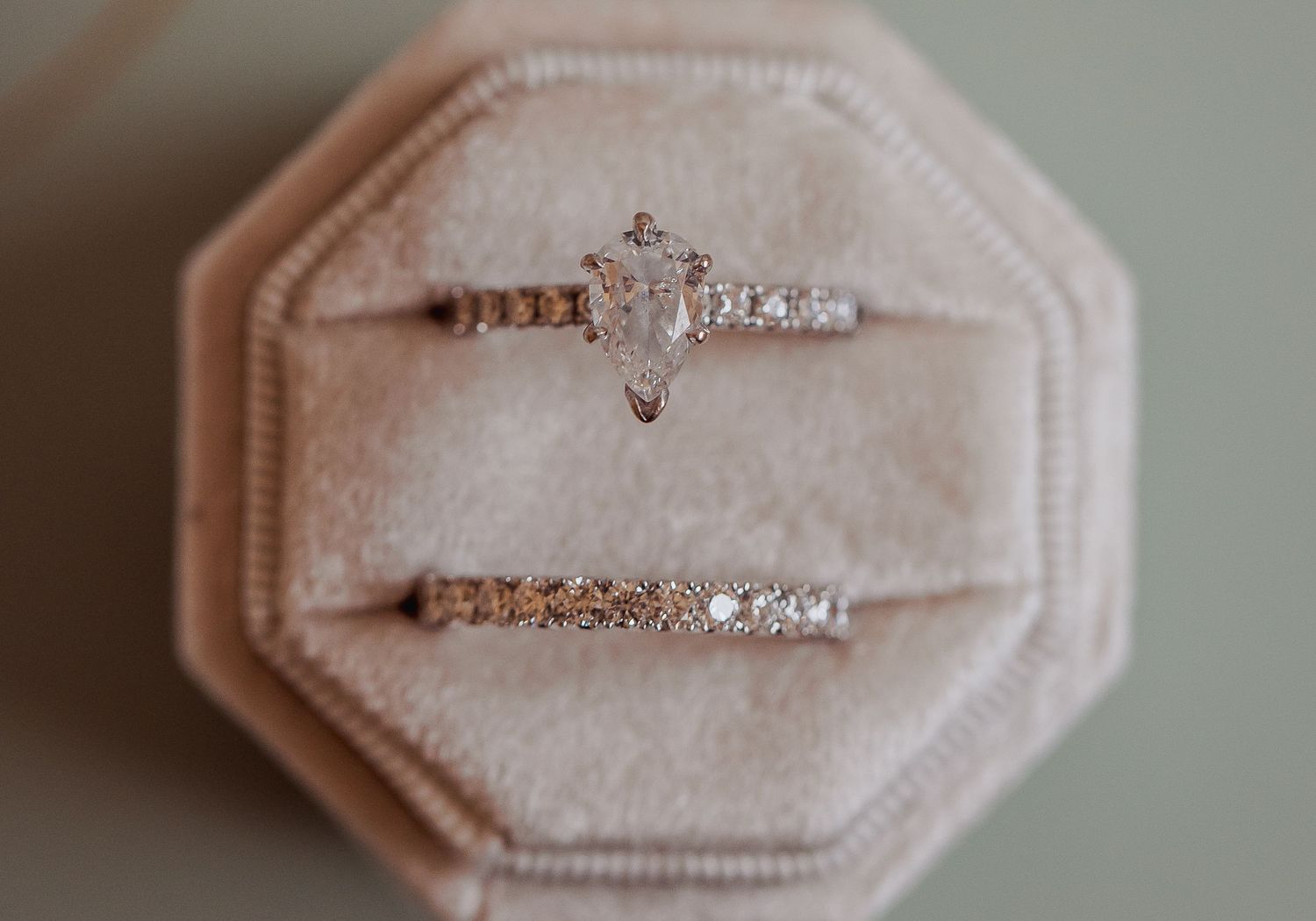 Rose gold engagement ring with diamonds displayed on white cushion shown from multiple angles in a sequence of images.