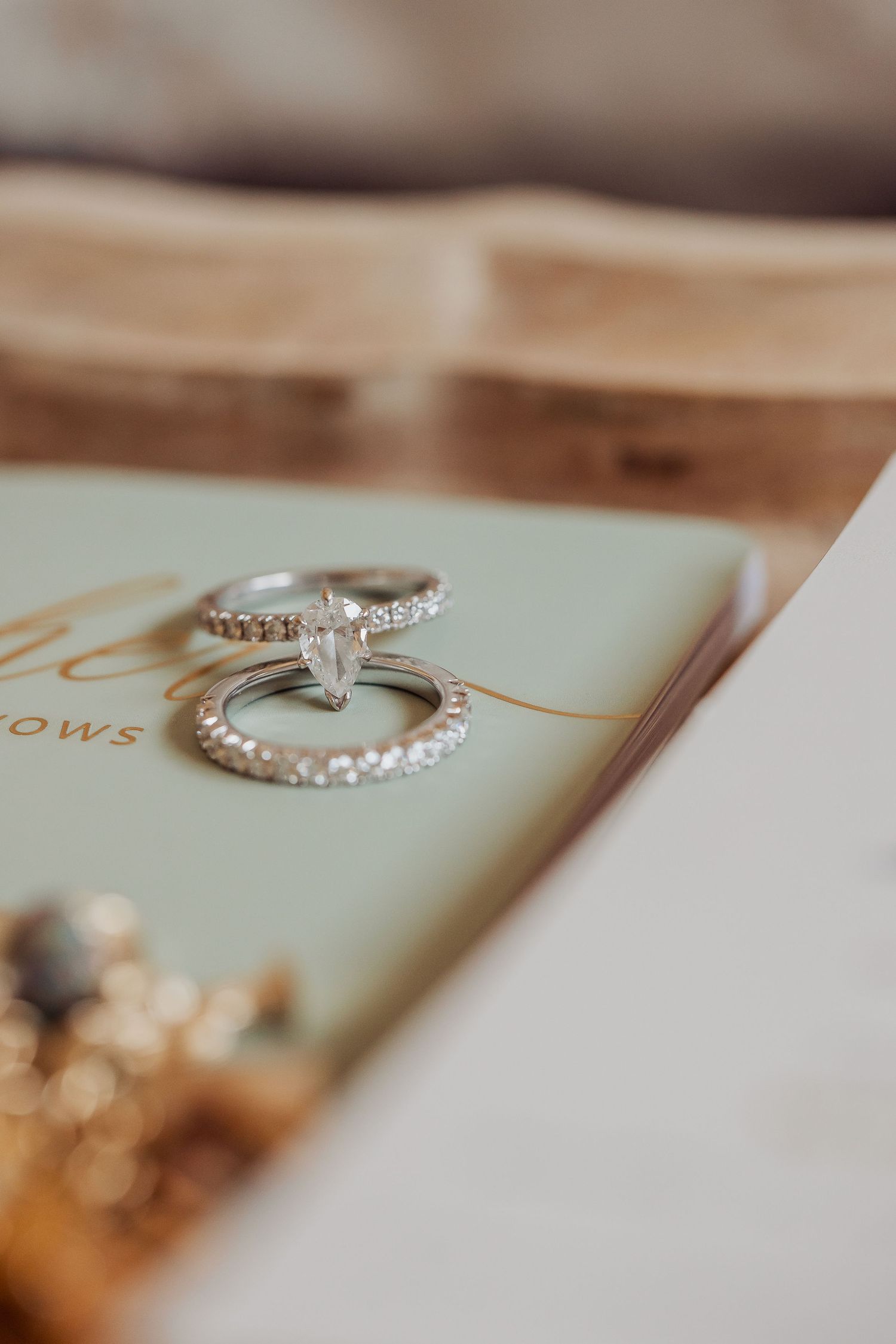 Elegant diamond engagement rings displayed on a light colored surface with delicate details and sparkle.