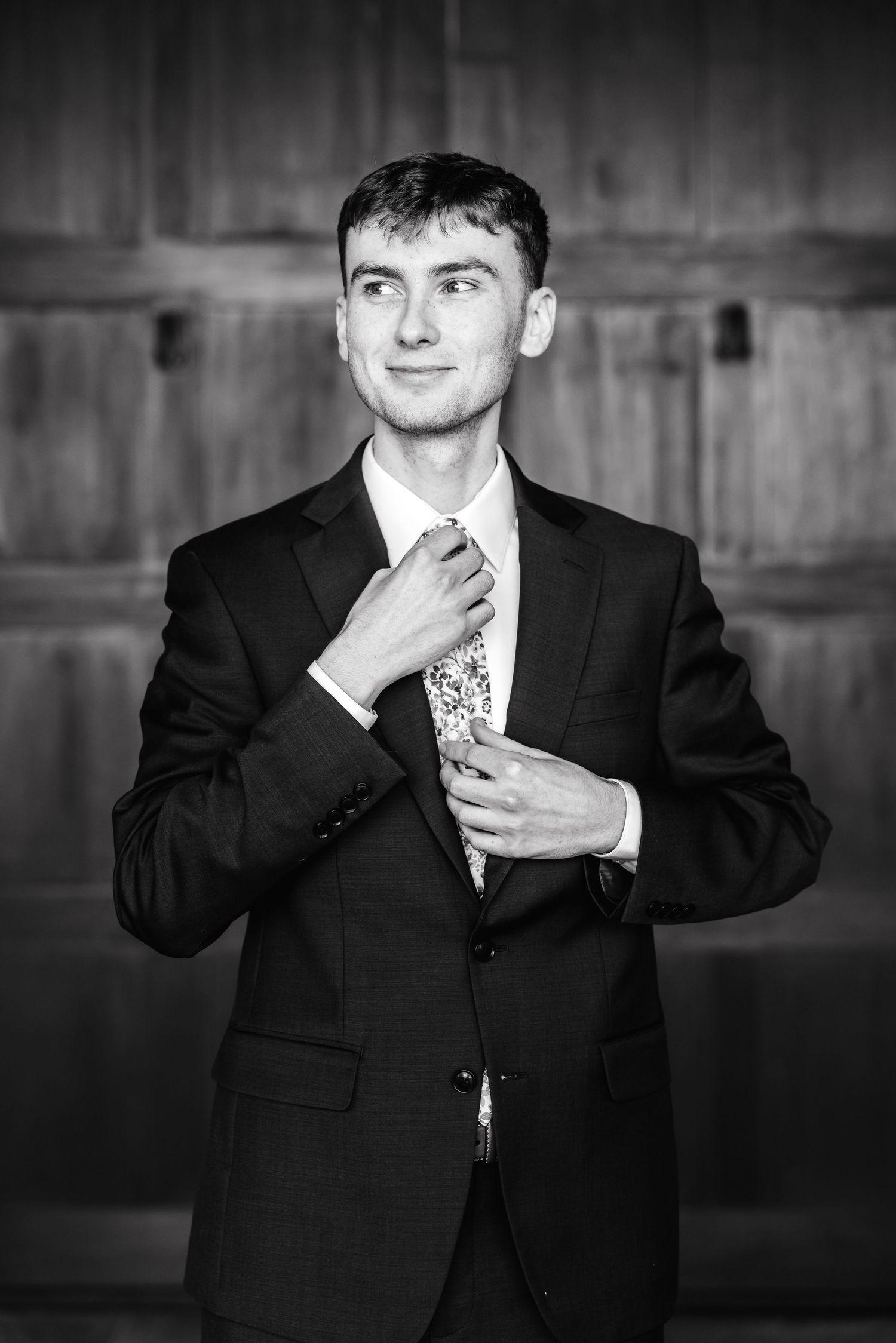 Black and white photo sequence showing a groom adjusting his tie and collar in a formal suit.