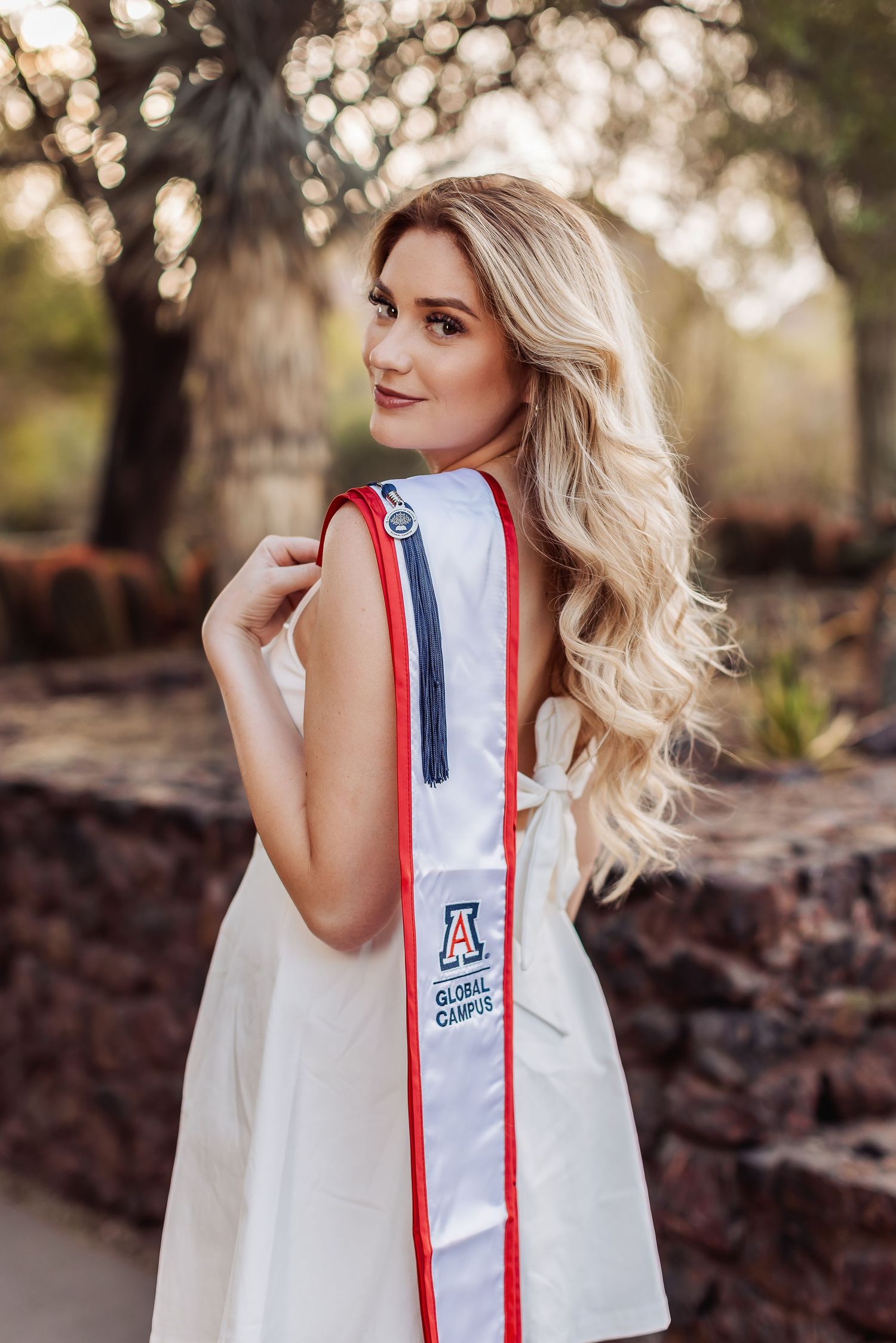 A fashion photo sequence shows a white sleeveless top with red and blue stripes and university logo from different angles.