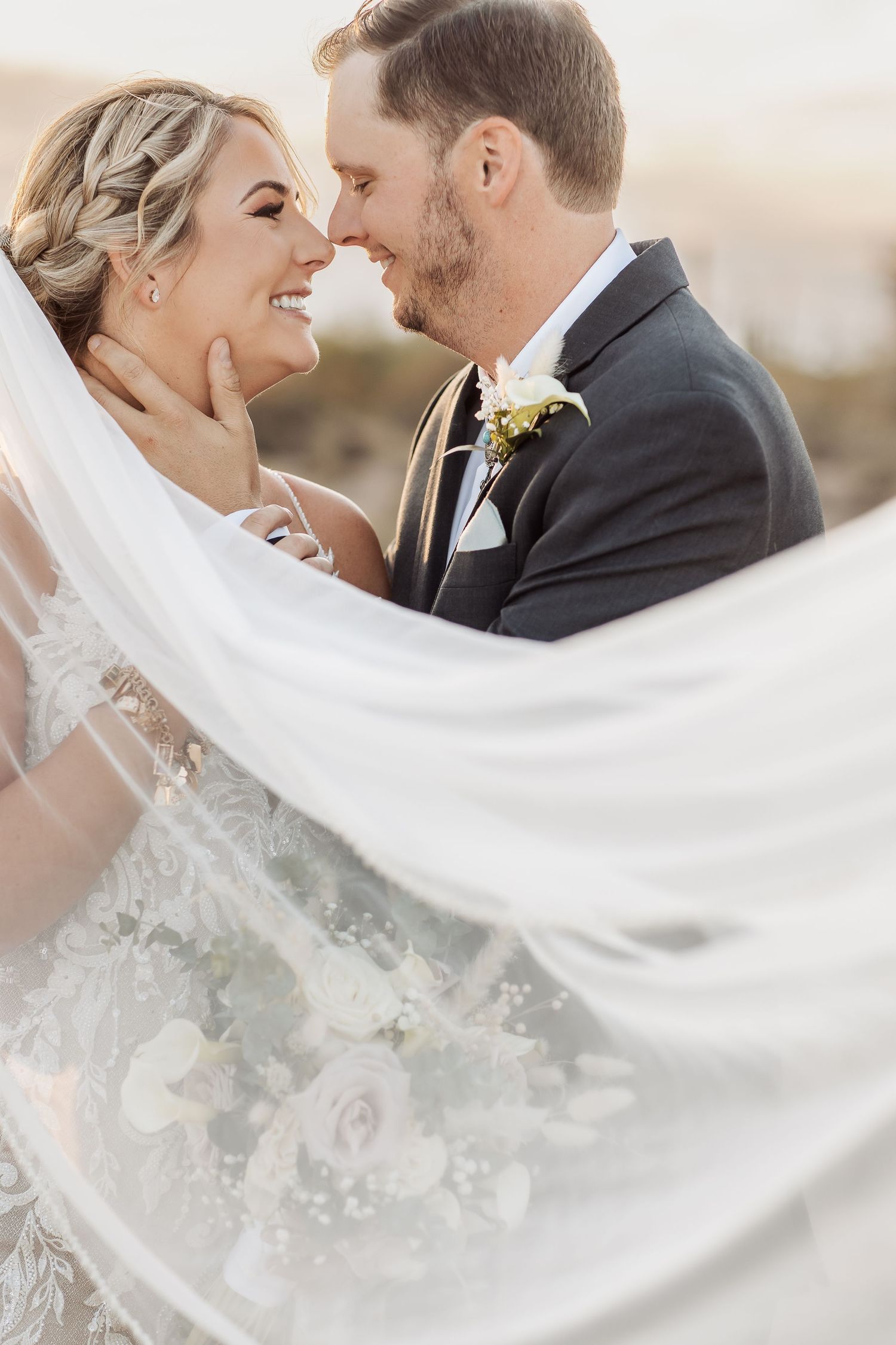 White bridal veil flowing in the breeze during an outdoor desert wedding photoshoot.
