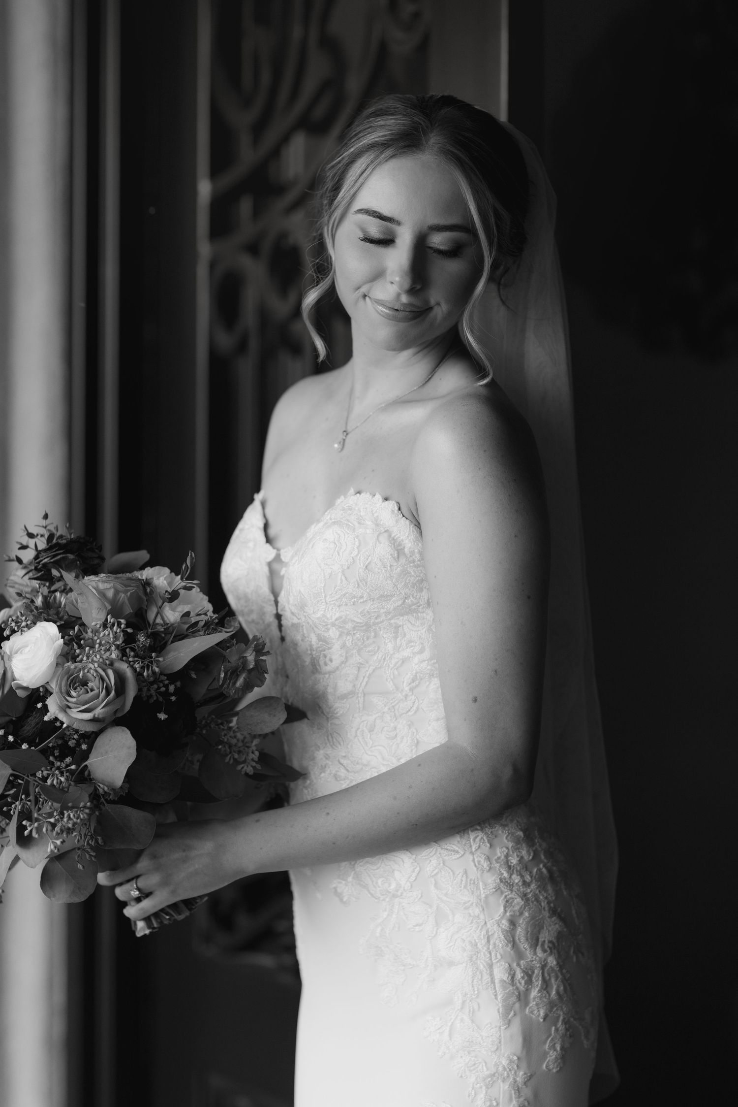 Black and white portrait series showing intimate moments with a bride holding her wedding bouquet.