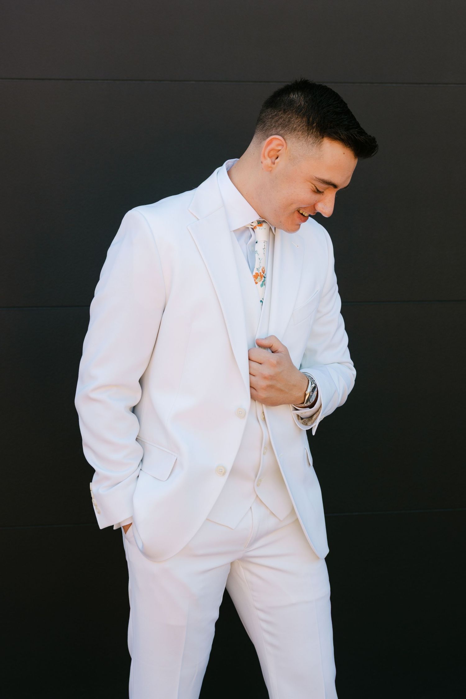 A series of dynamic poses showing a person in an all-white suit against a dark background.