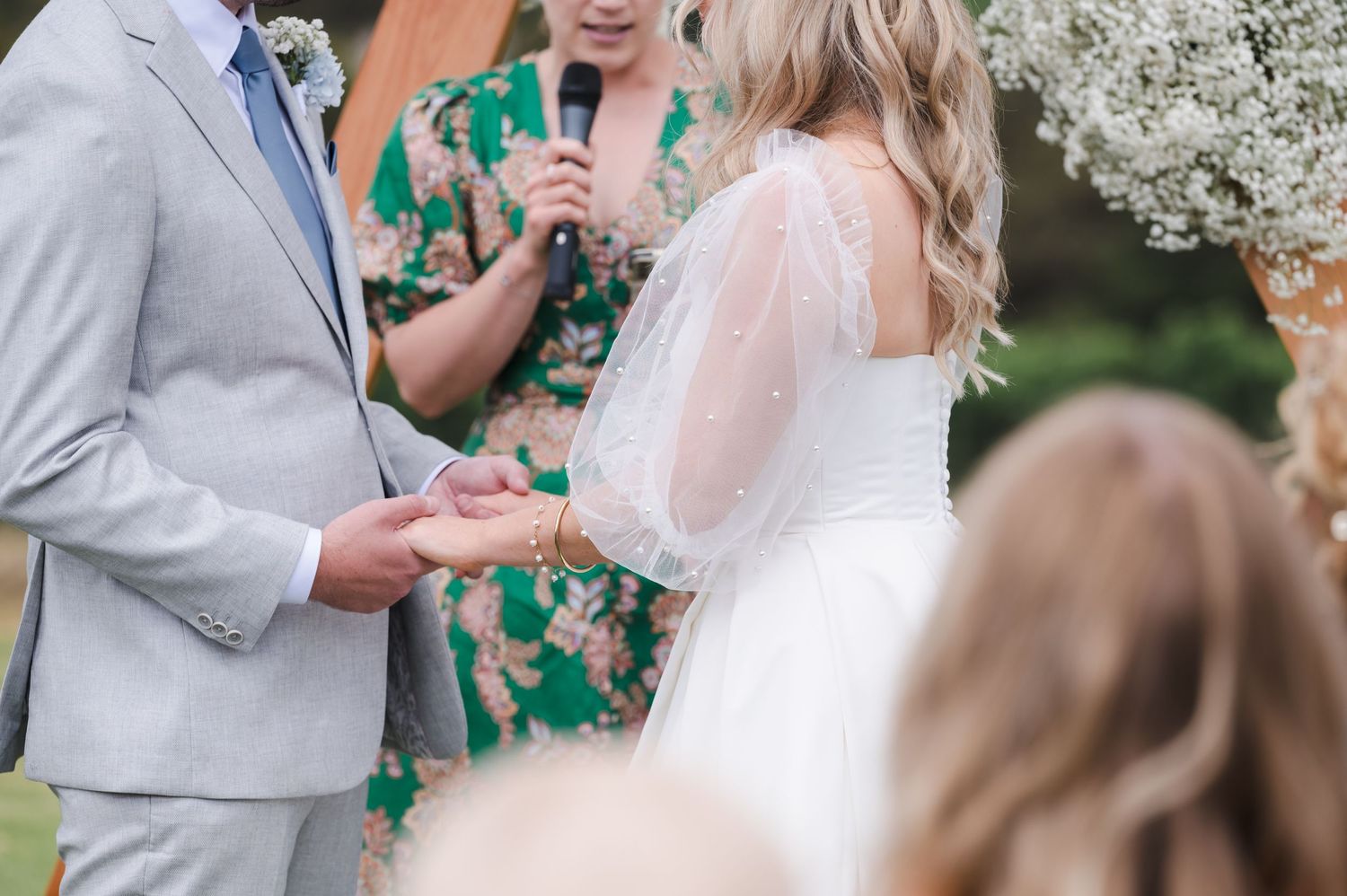 Exchange of rings during an outdoor wedding ceremony with guests looking on.
Clare Valley
South Australia
Wedding Photography